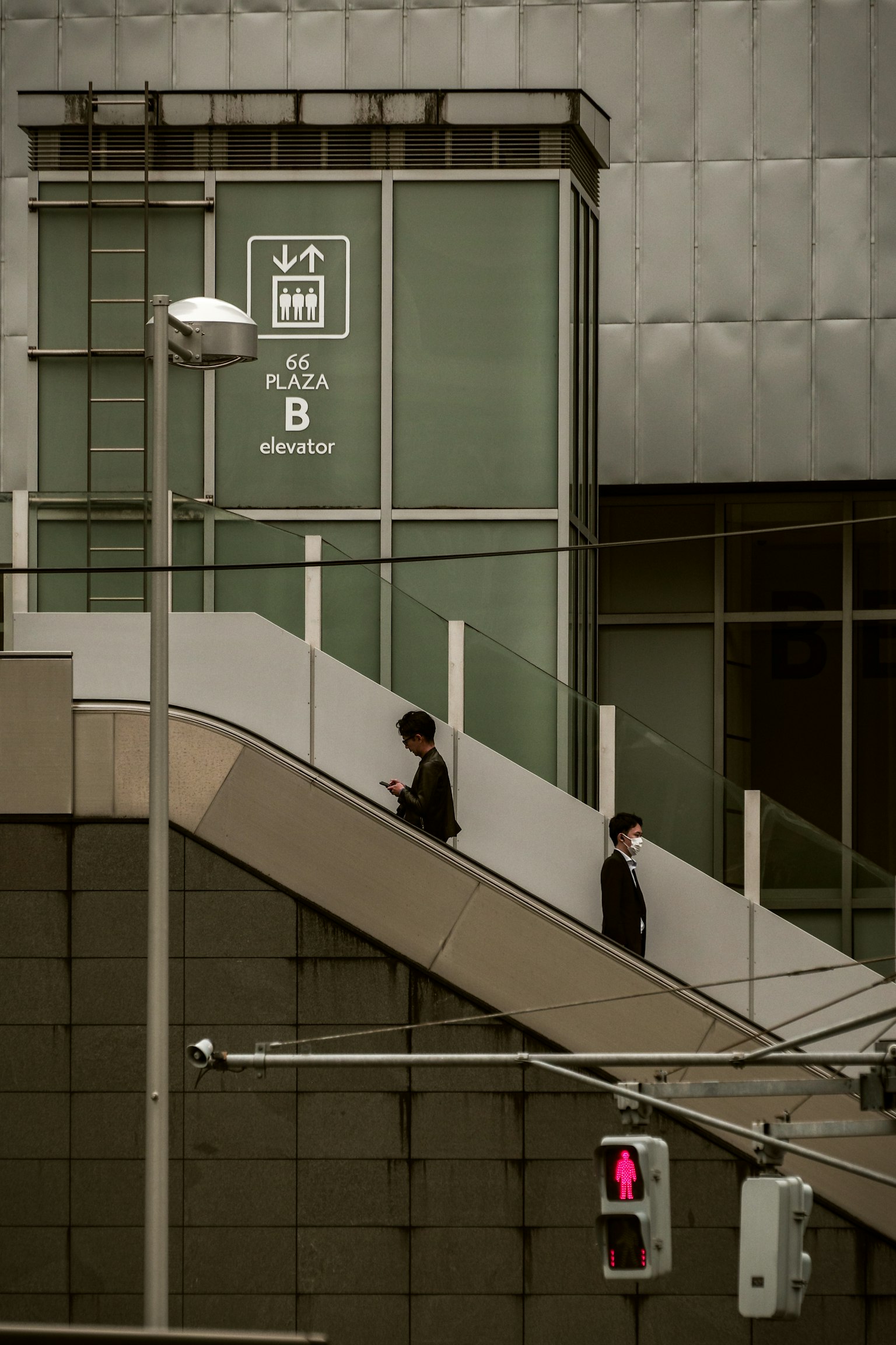 Two businessmen walking down stairs with a modern building backdrop