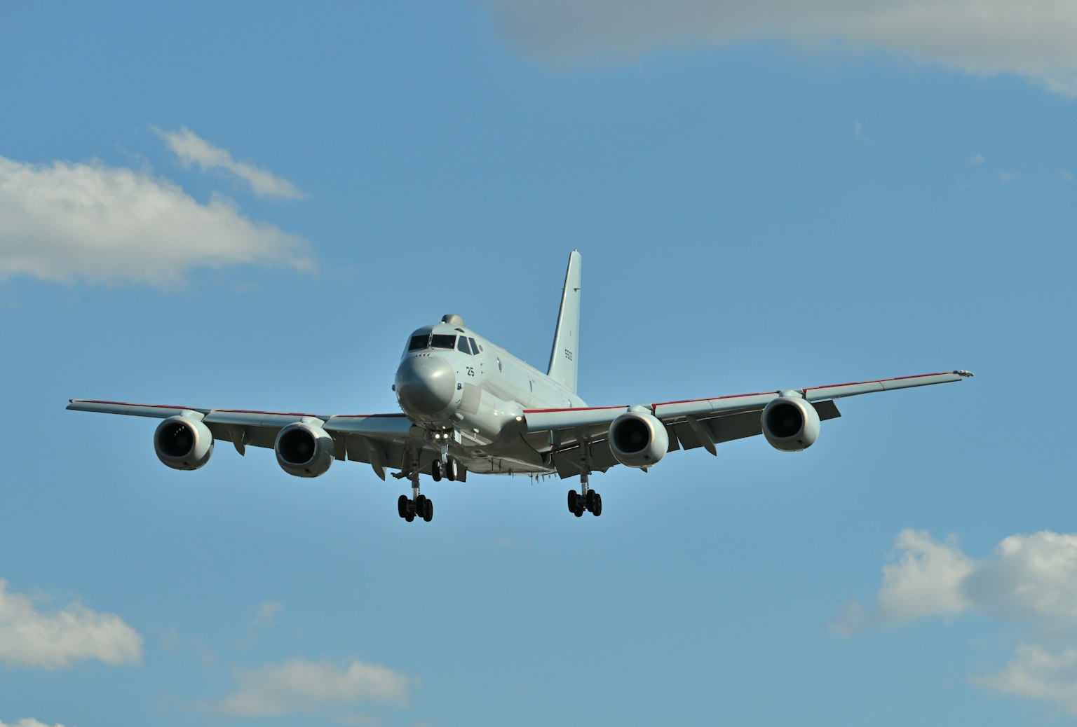 Landing airplane against a blue sky