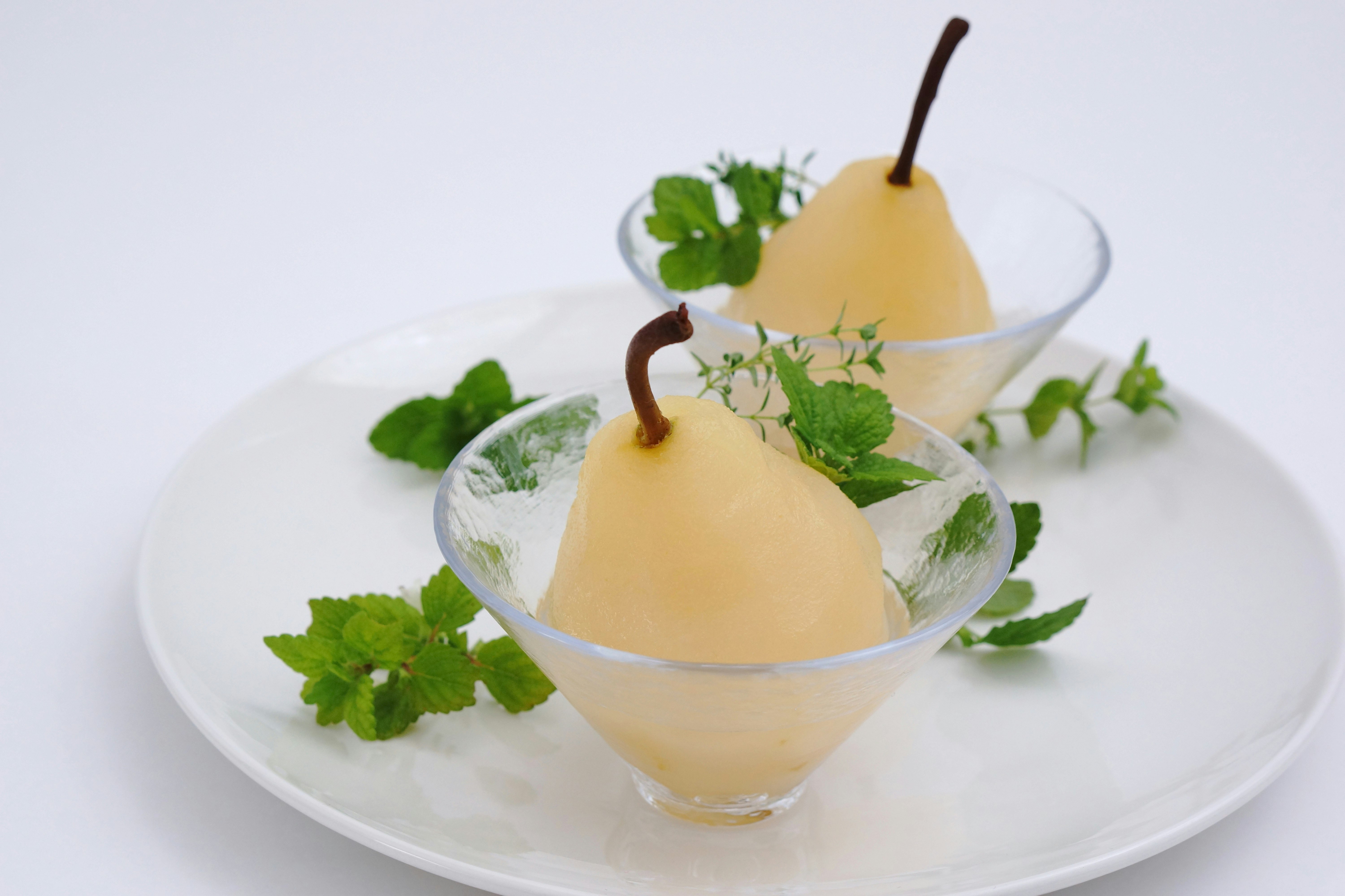 Pear cocktail dessert glasses garnished with mint