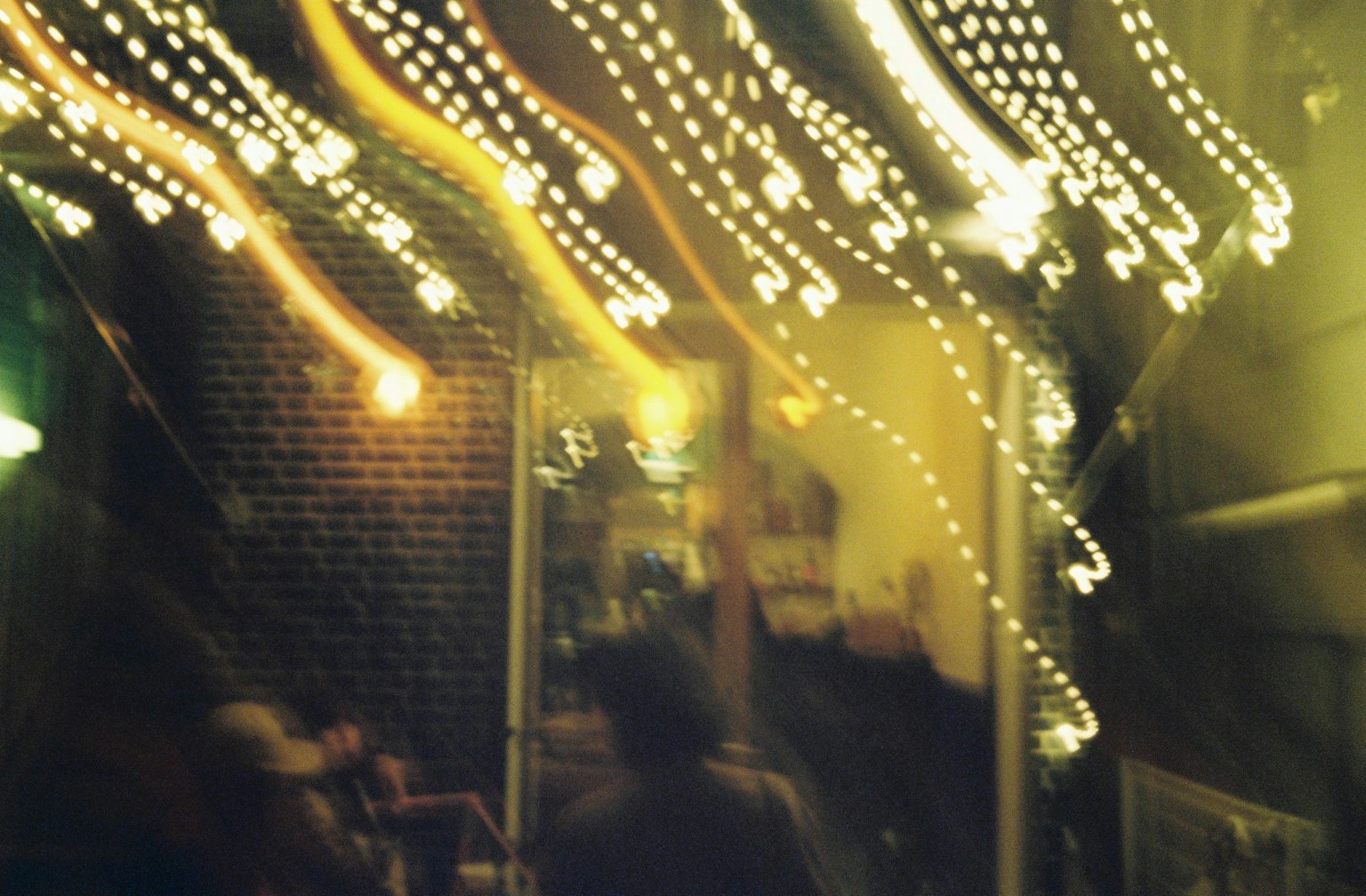 Blurry stream of lights with silhouettes of people in a night scene