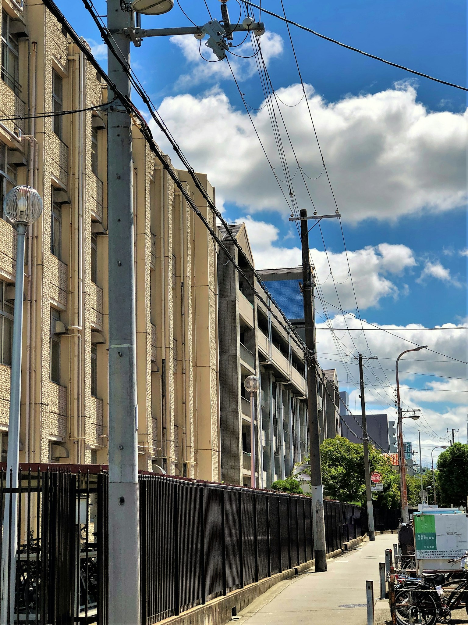 Street view featuring a building facade and blue sky