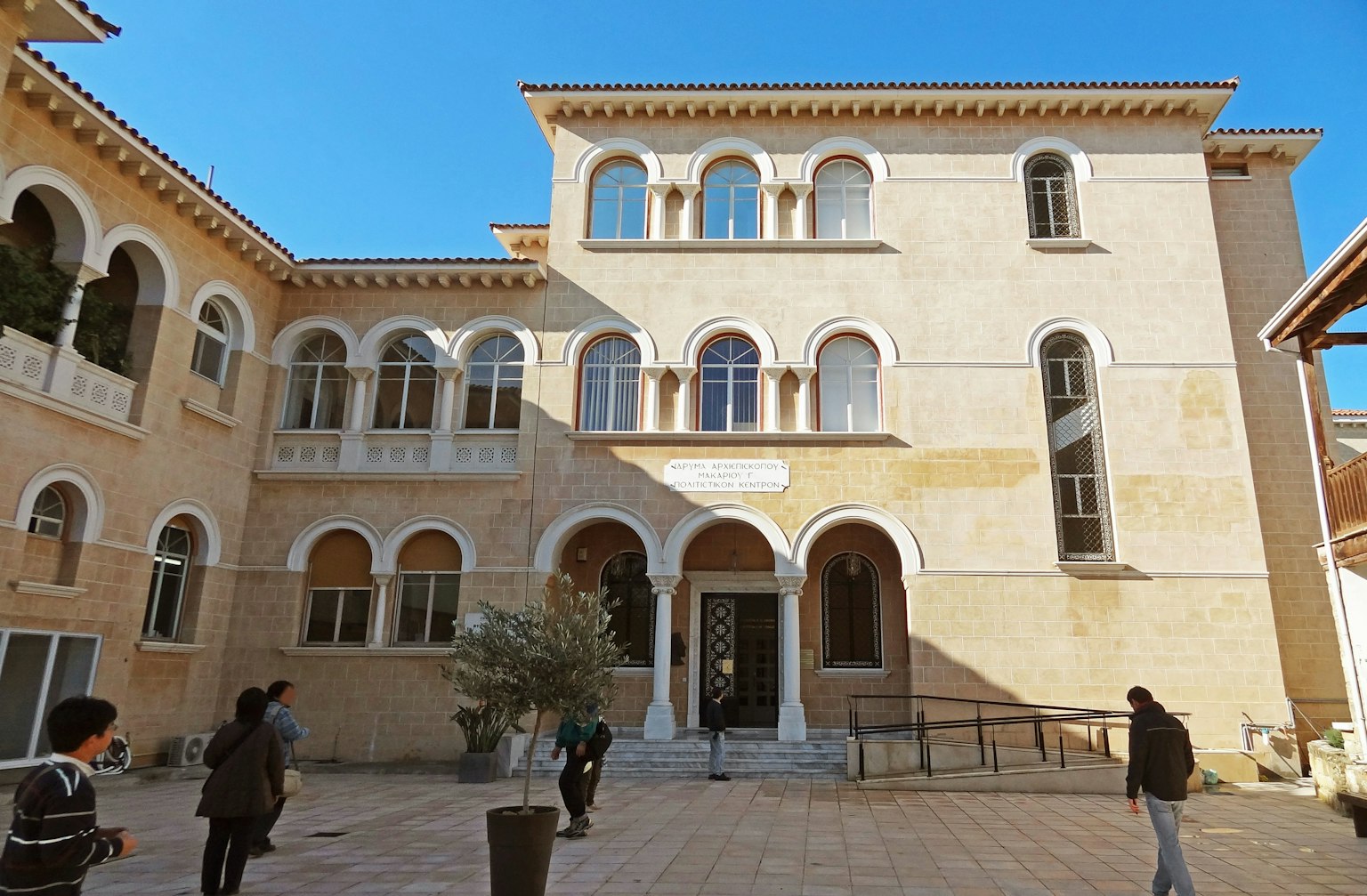 Bâtiment historique avec fenêtres en arc sous un ciel bleu