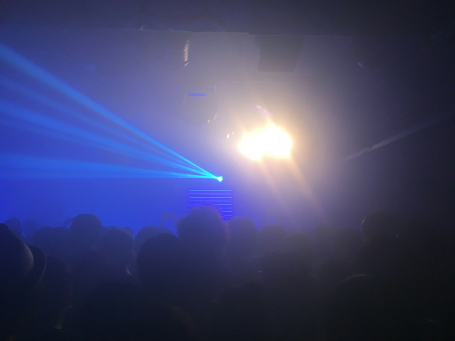 Atmosfera di un club con raggi laser blu e illuminazione brillante