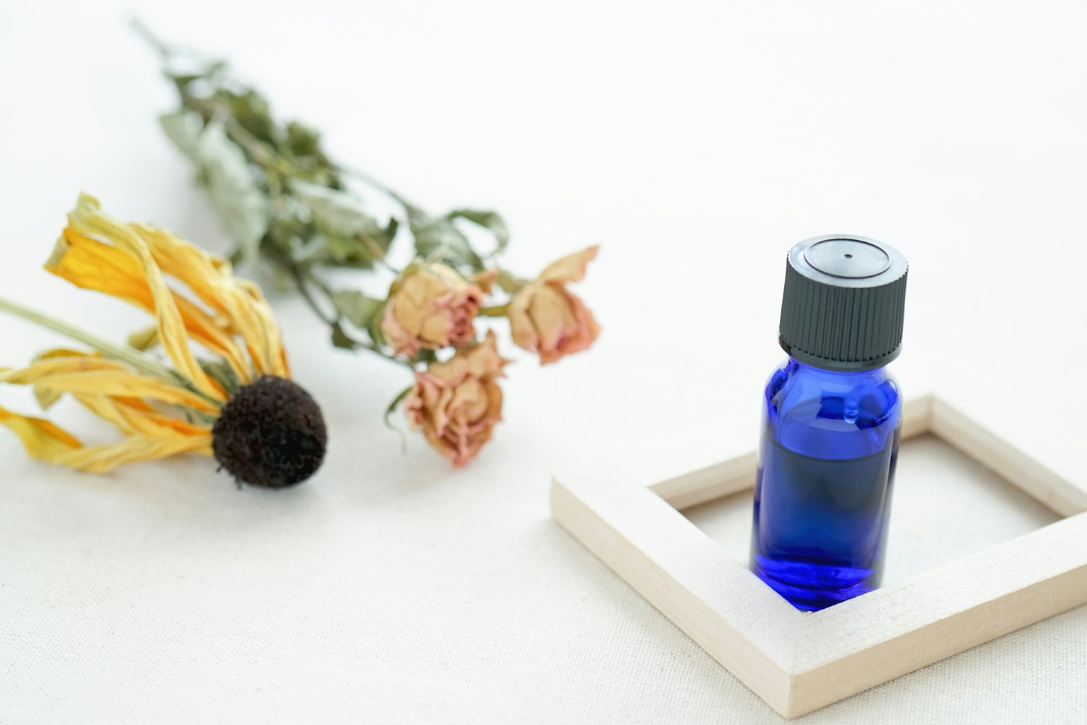 Blue bottle with dried flowers arrangement