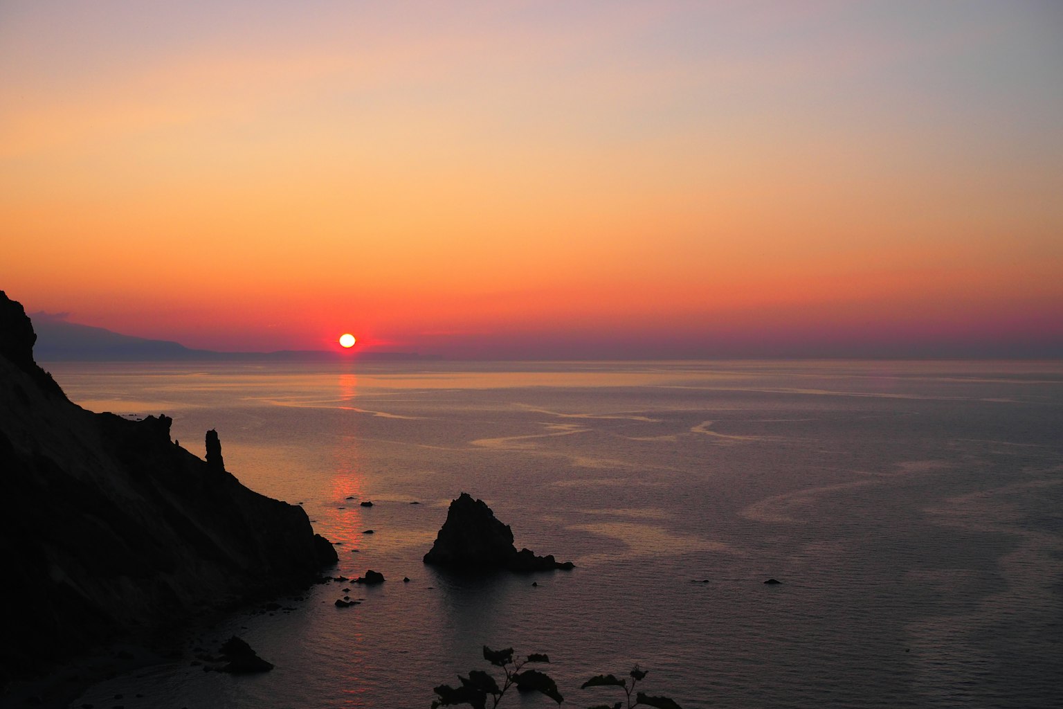 Beautiful sunset over the ocean with gradient colors of blue and orange
