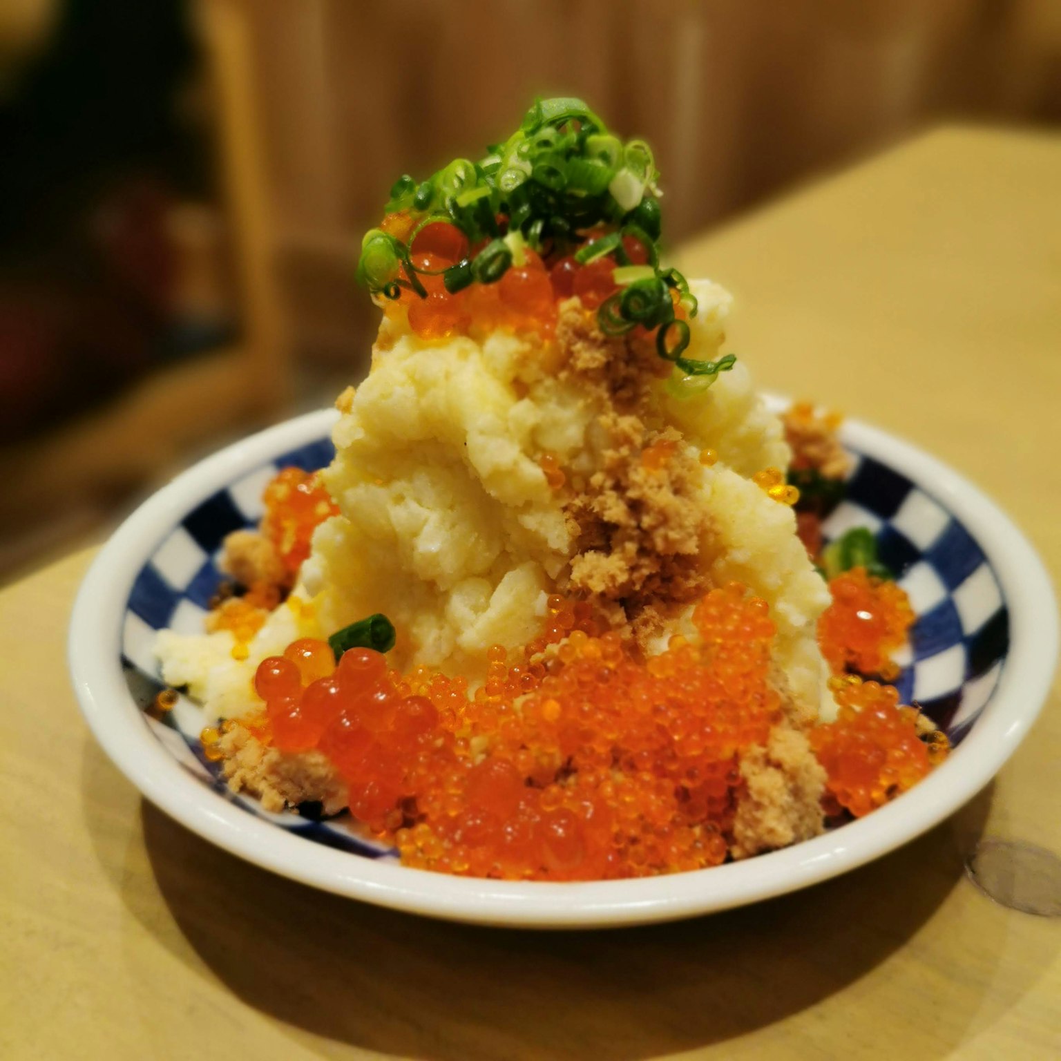 A delicious mound of mashed potatoes topped with salmon roe and green onions