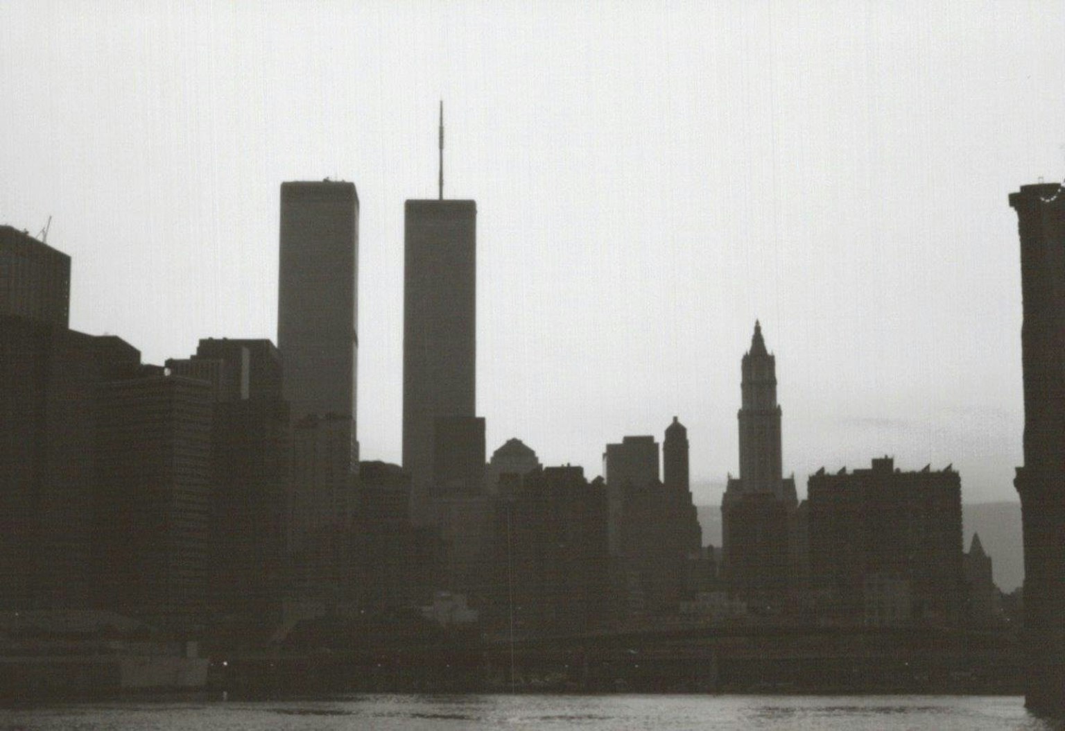 Silhouette of New York skyline featuring Twin Towers and historic buildings