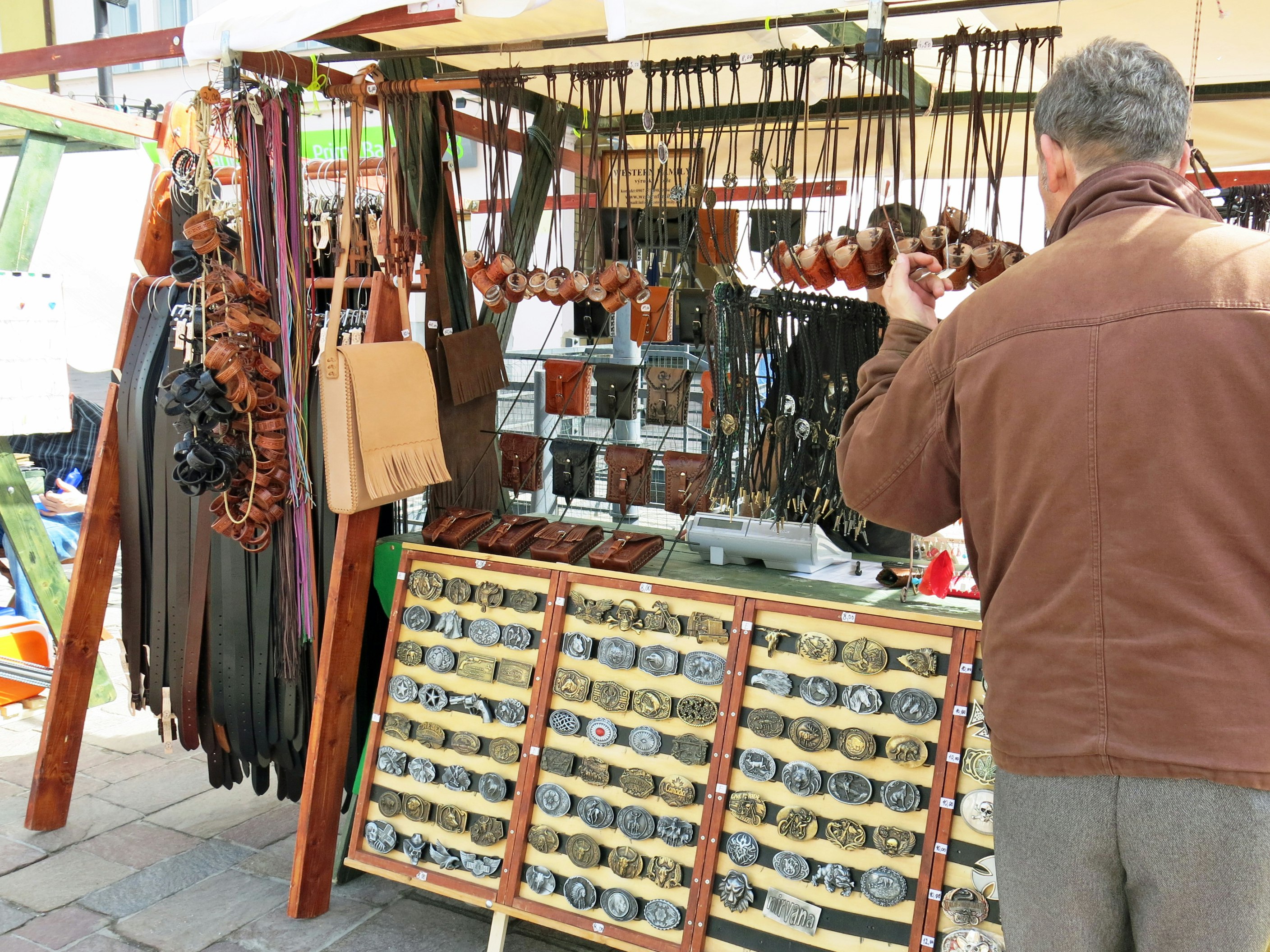 outdoor market stall with rows of accessories and wristwatches