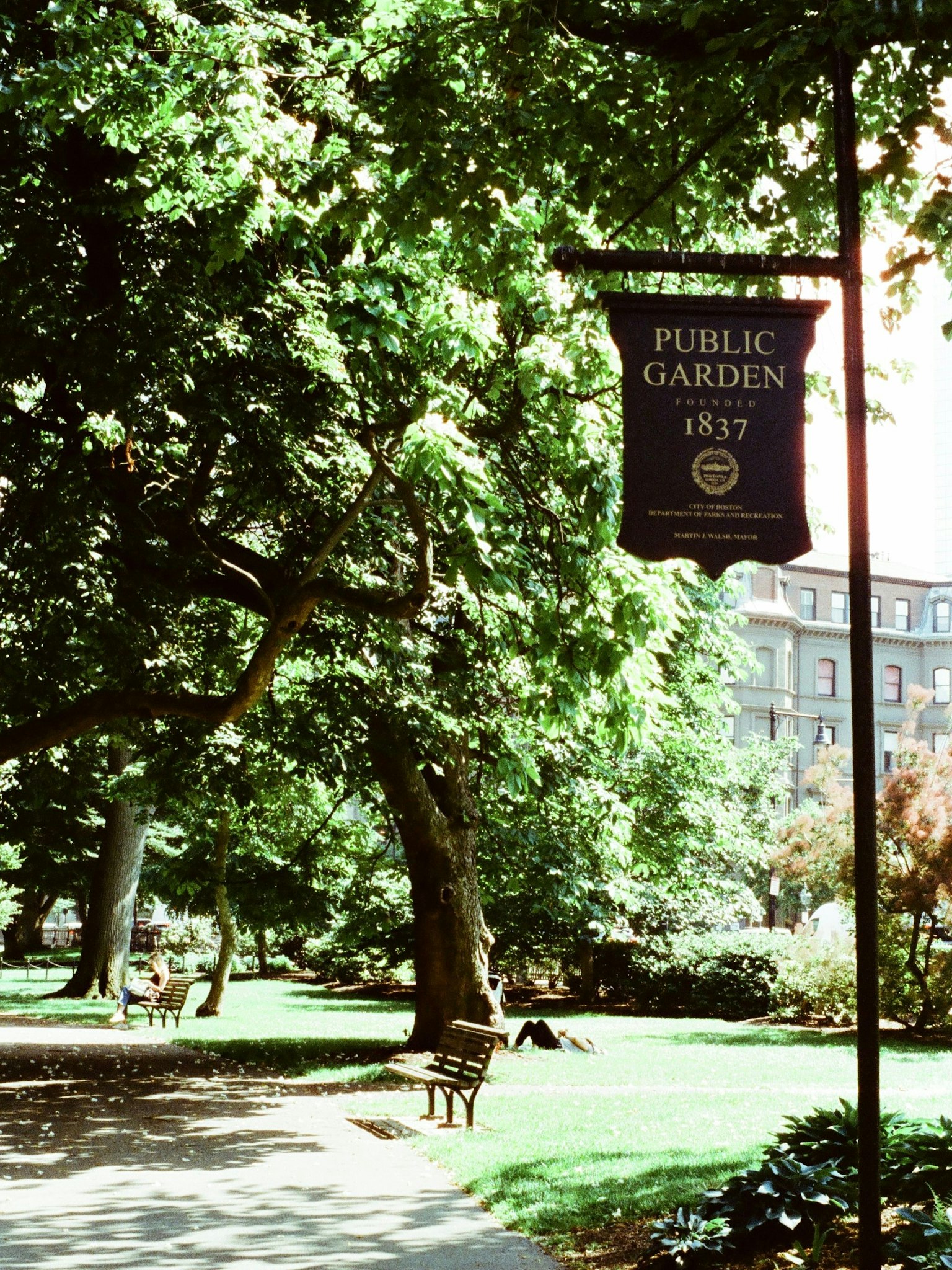 Public Garden sign with lush greenery and trees