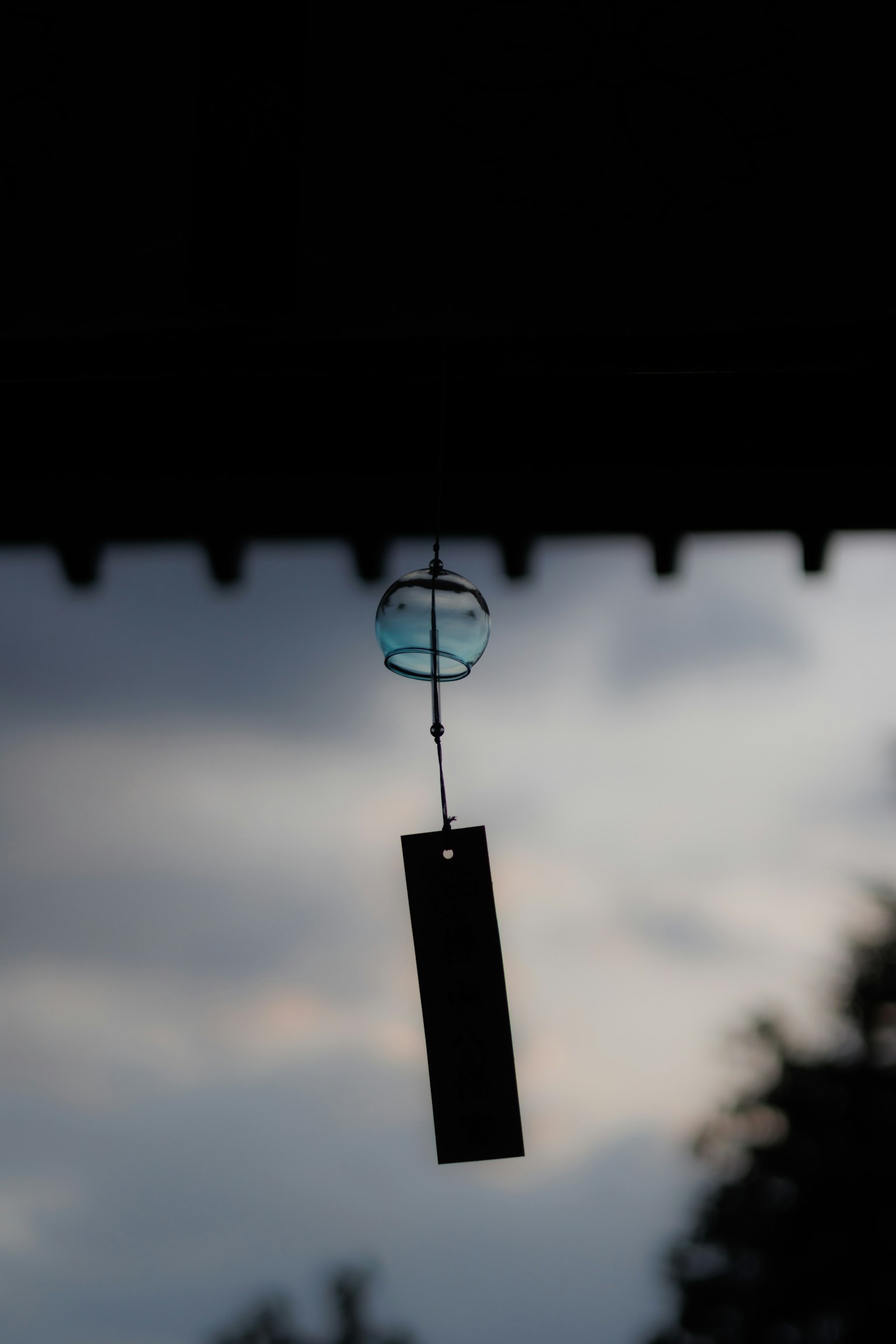 Angin lonceng bersiluet melawan langit senja
