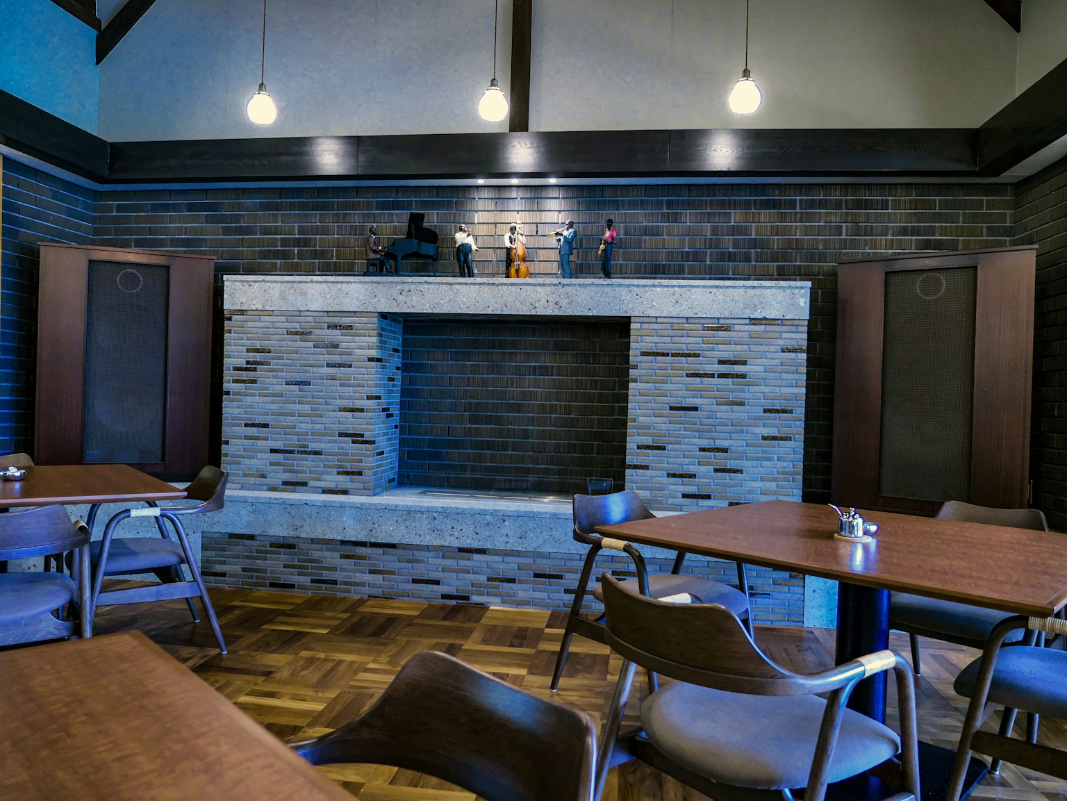 Modern café interior featuring ambient lighting and a stone fireplace