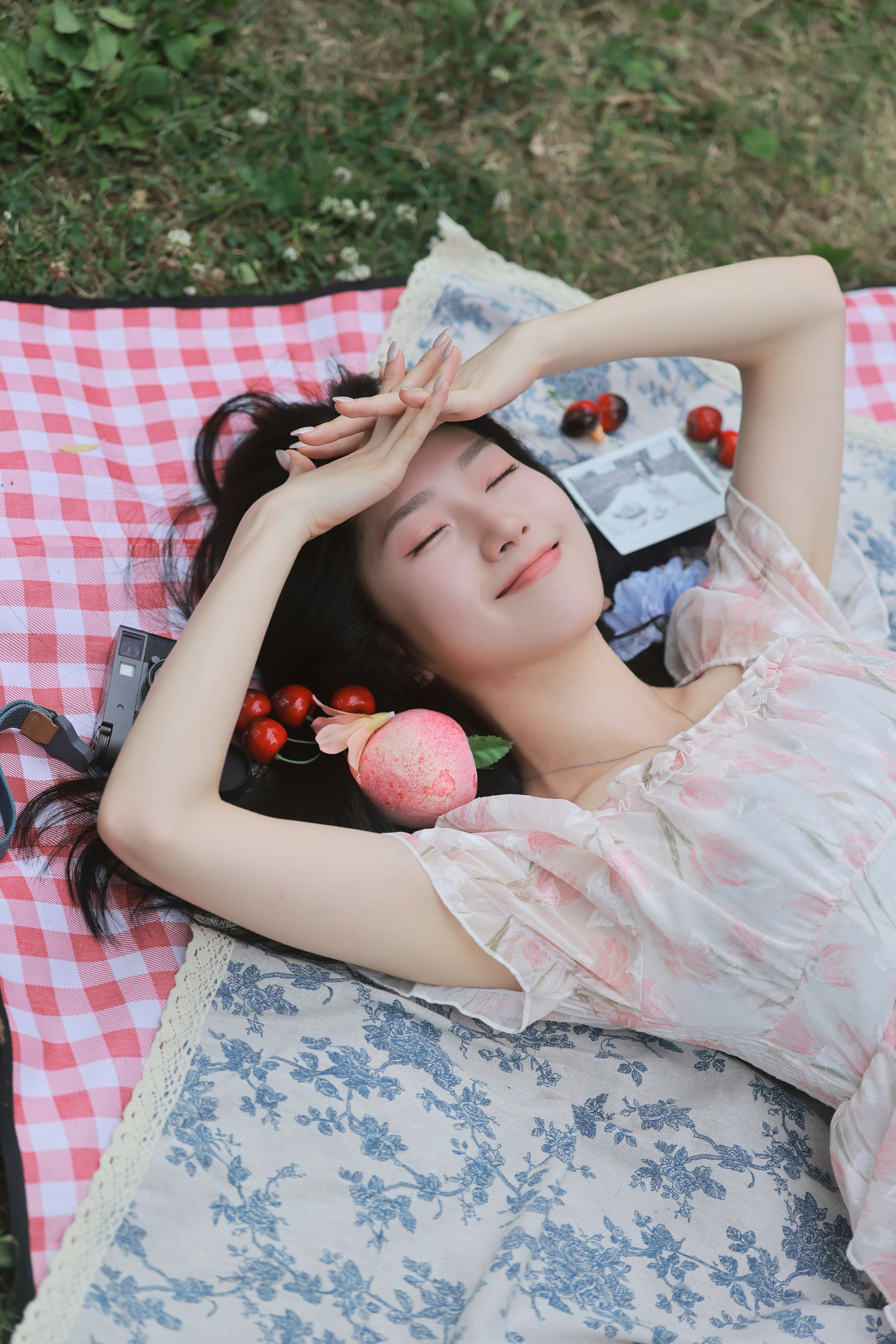 woman lying on a pink checkered blanket