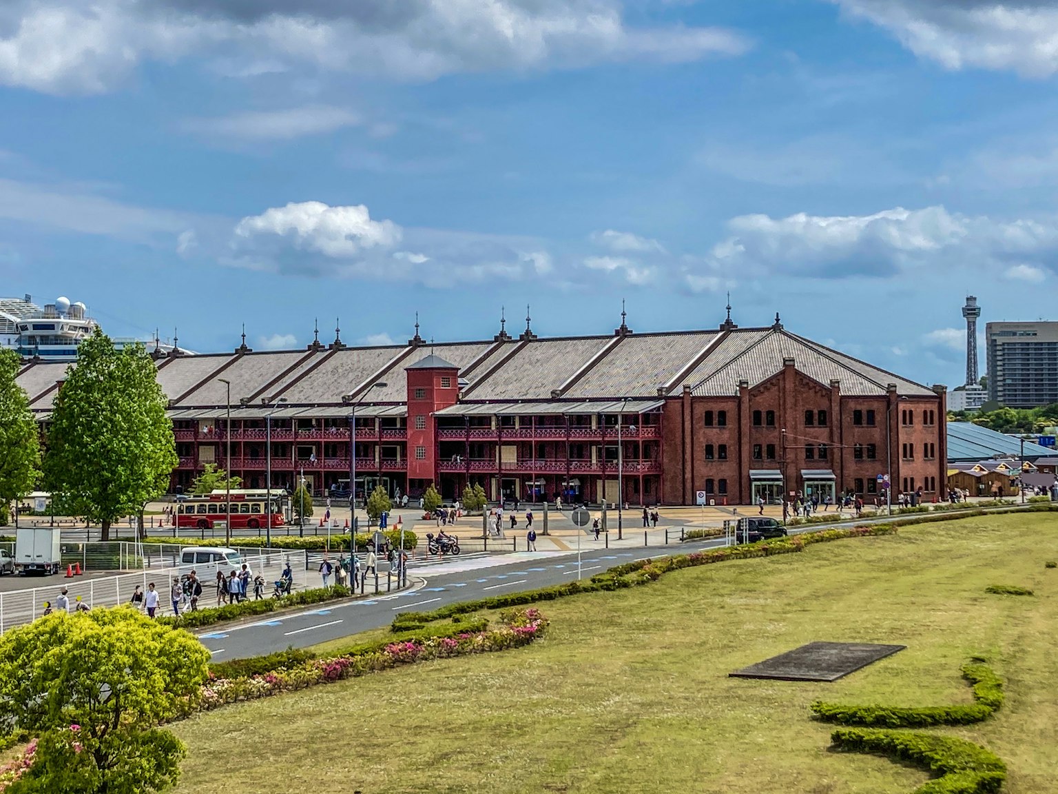 Red brick building under a blue sky with park