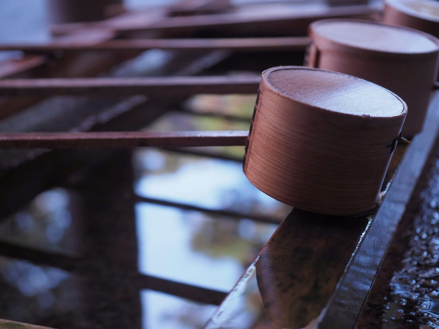 A serene scene featuring copper ladles arranged over water