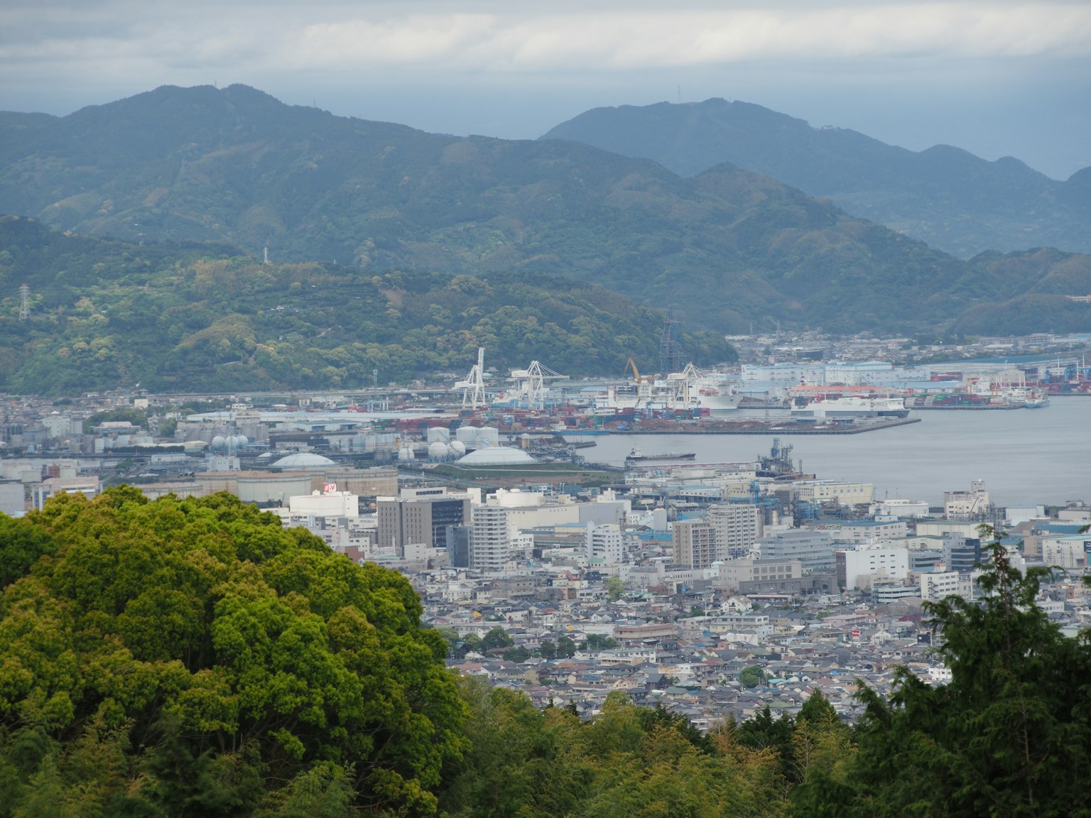 Panoramic view of a city with mountains and a harbor