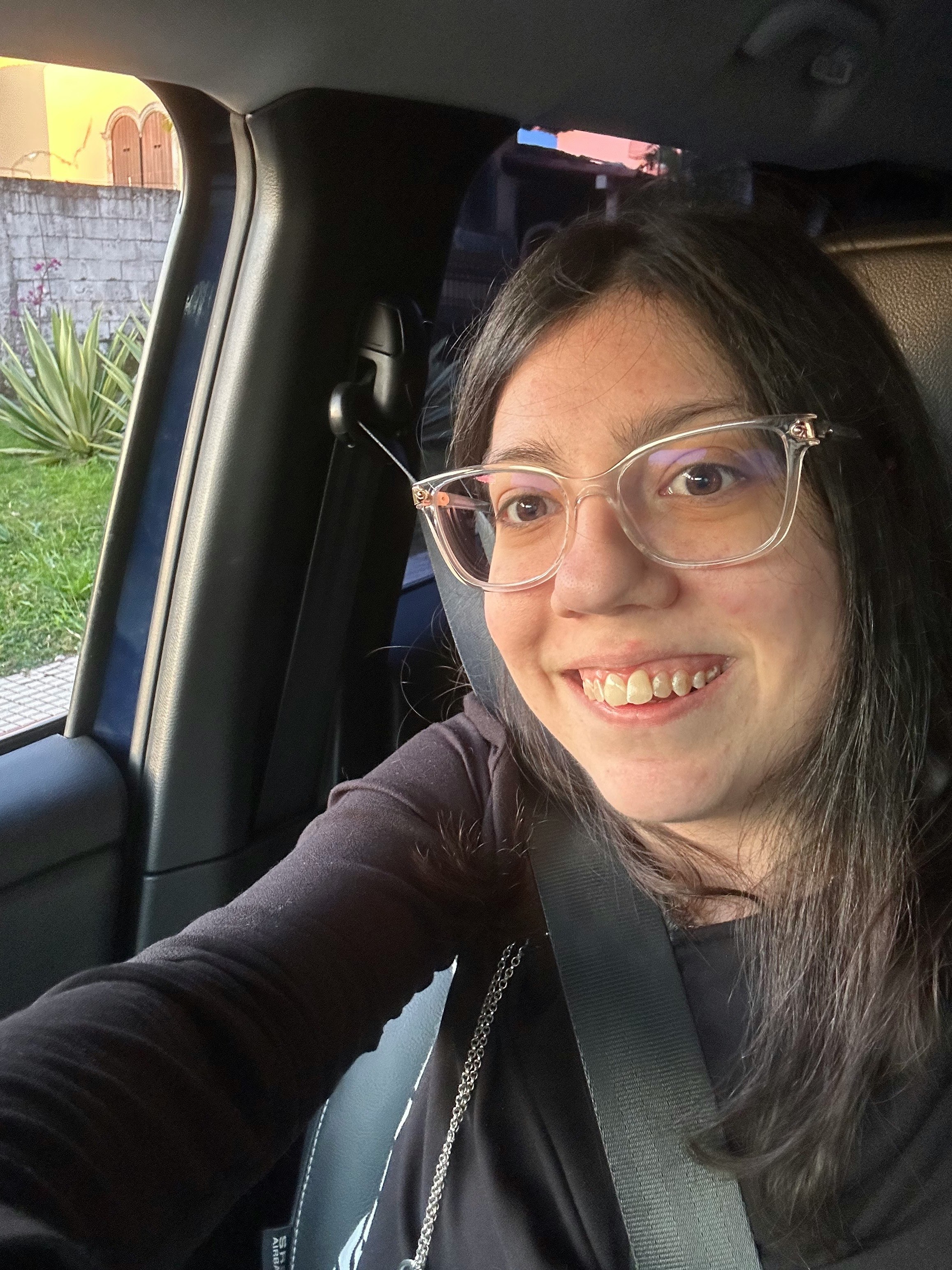 selfie of a smiling woman inside a car
