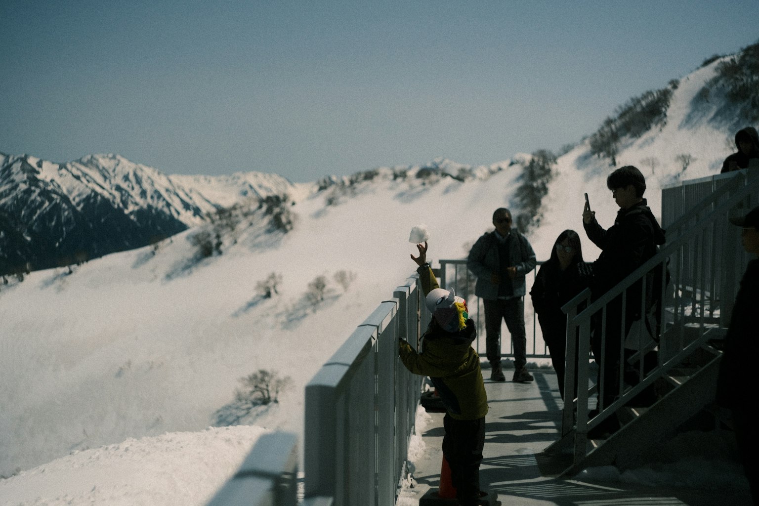 Tourists enjoying the snowy mountain view