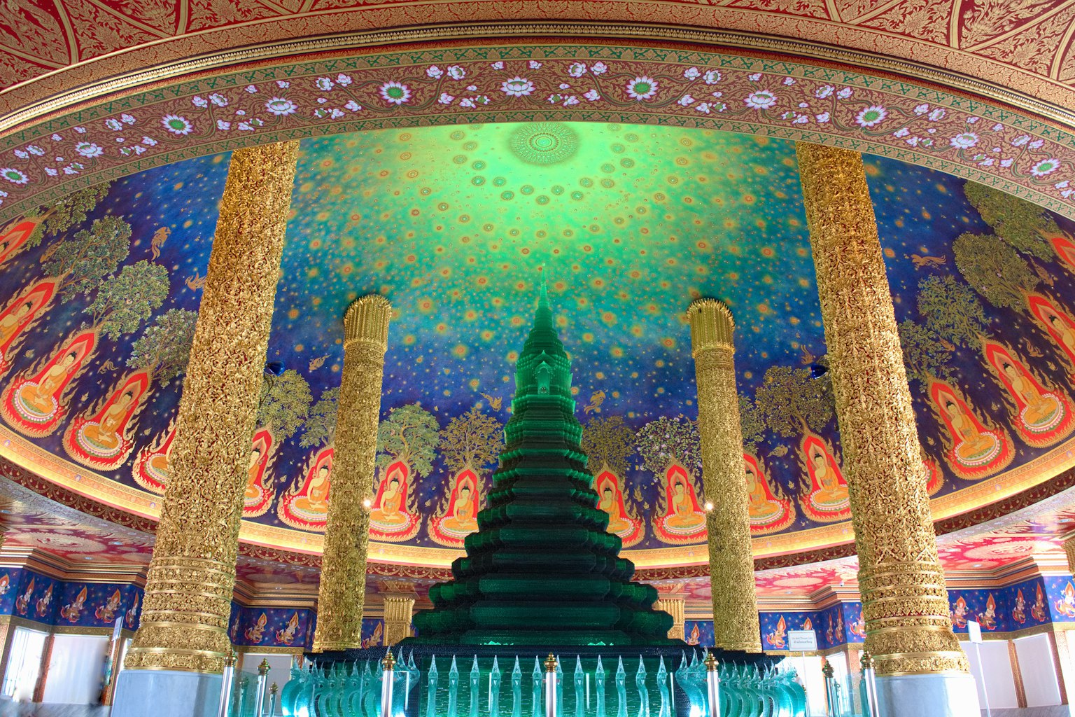 พื้นที่ภายในที่มีการตกแต่งสีเขียวคล้ายต้นคริสต์มาสและเพดานสีสันสดใส