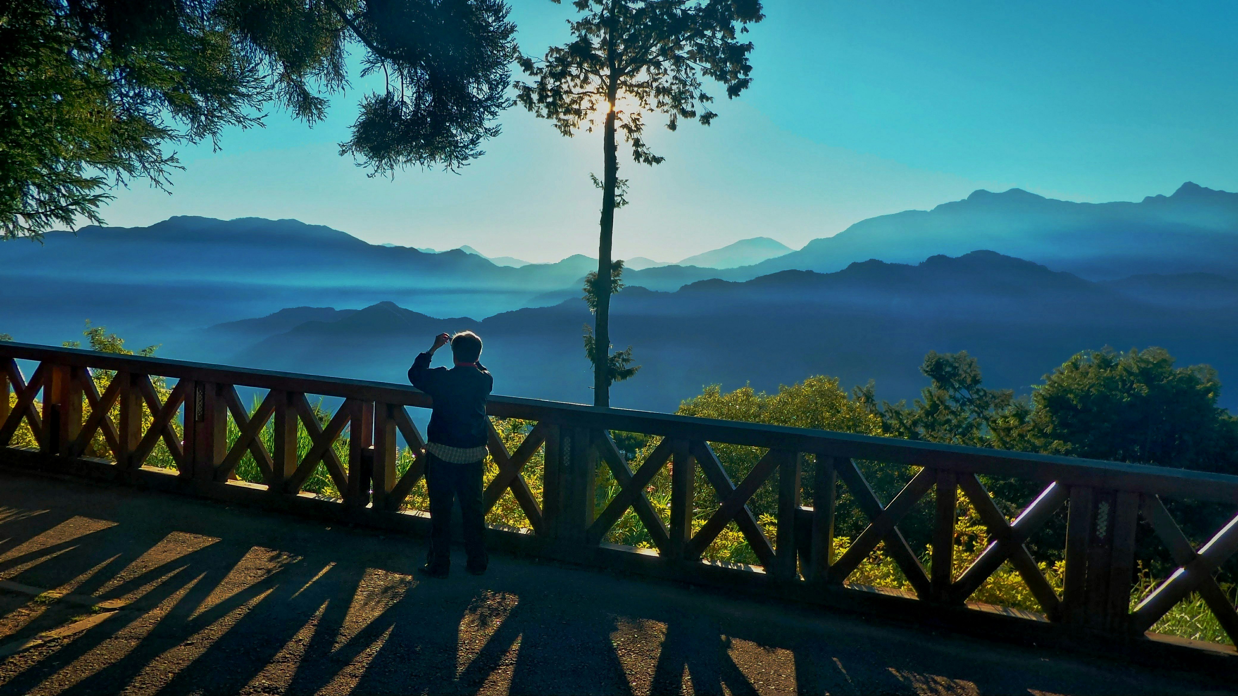 scenic view of a lake and mountain range from a viewpoint deck