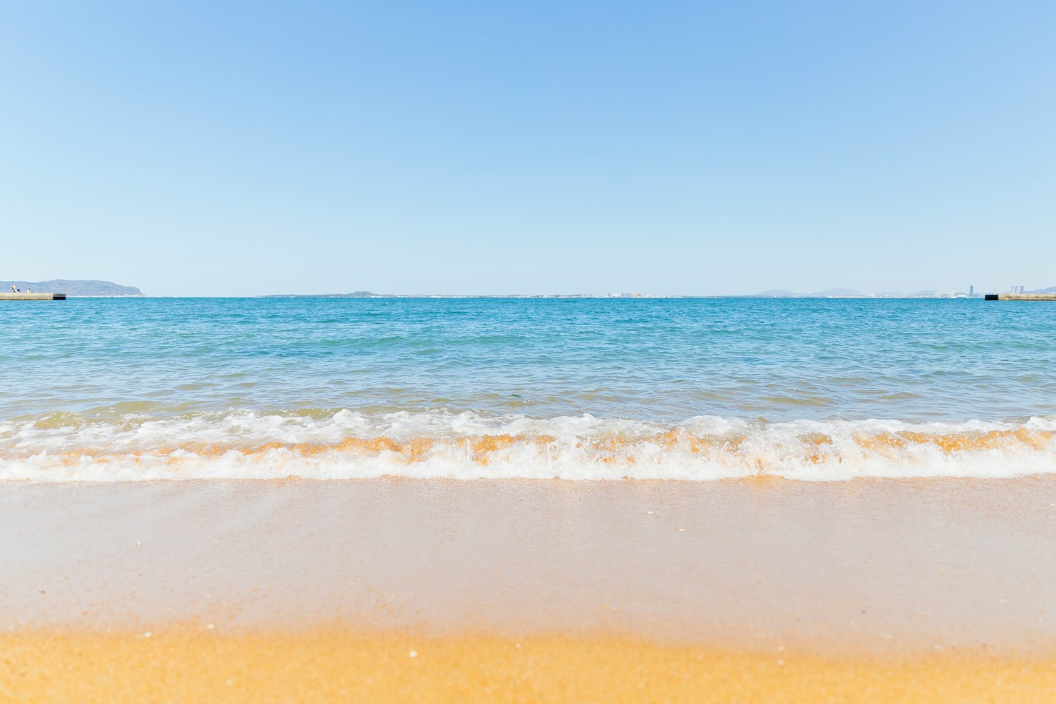 Scenic view of a blue sea and sandy beach