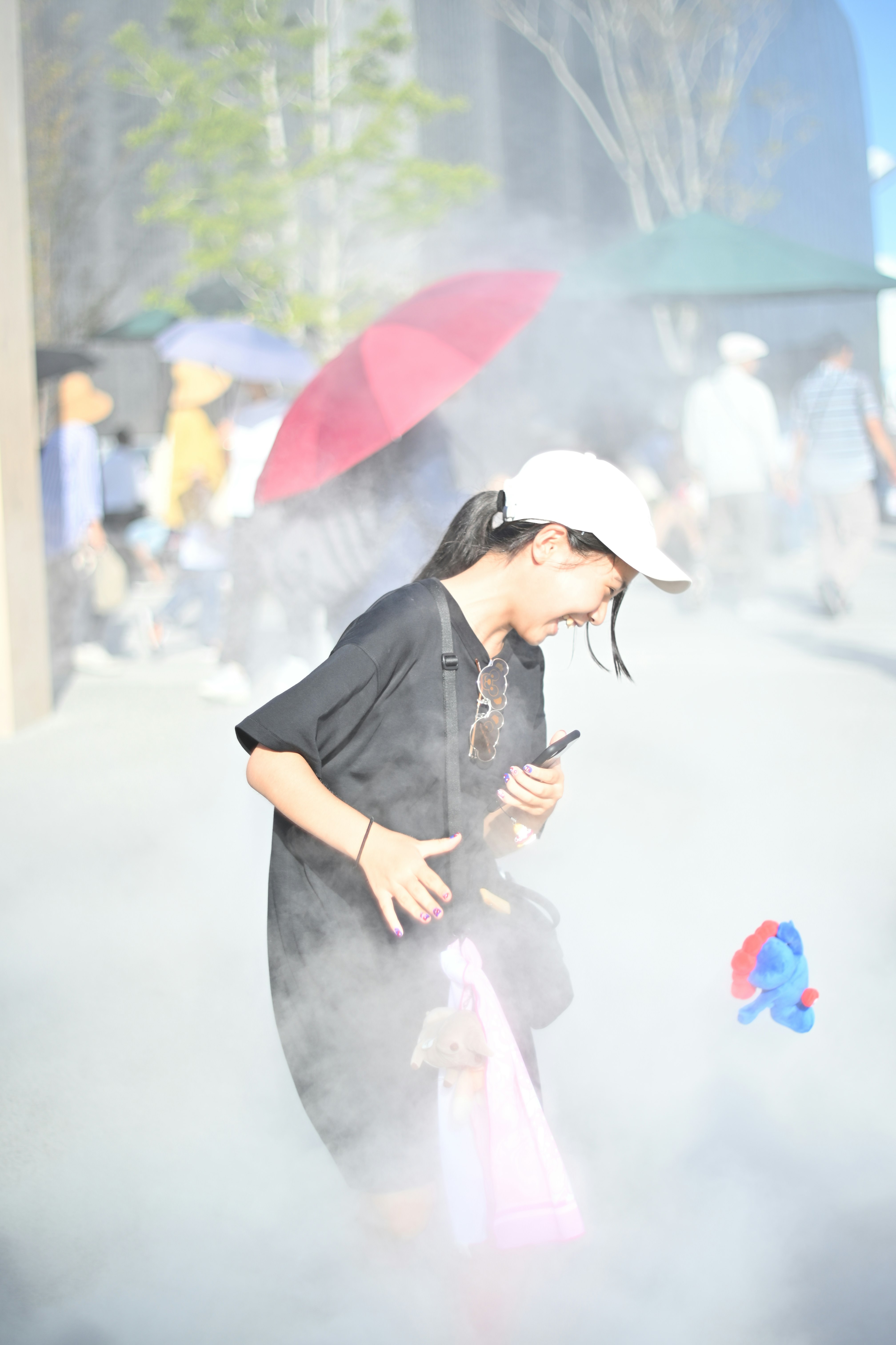 woman holding an umbrella in white smoke
