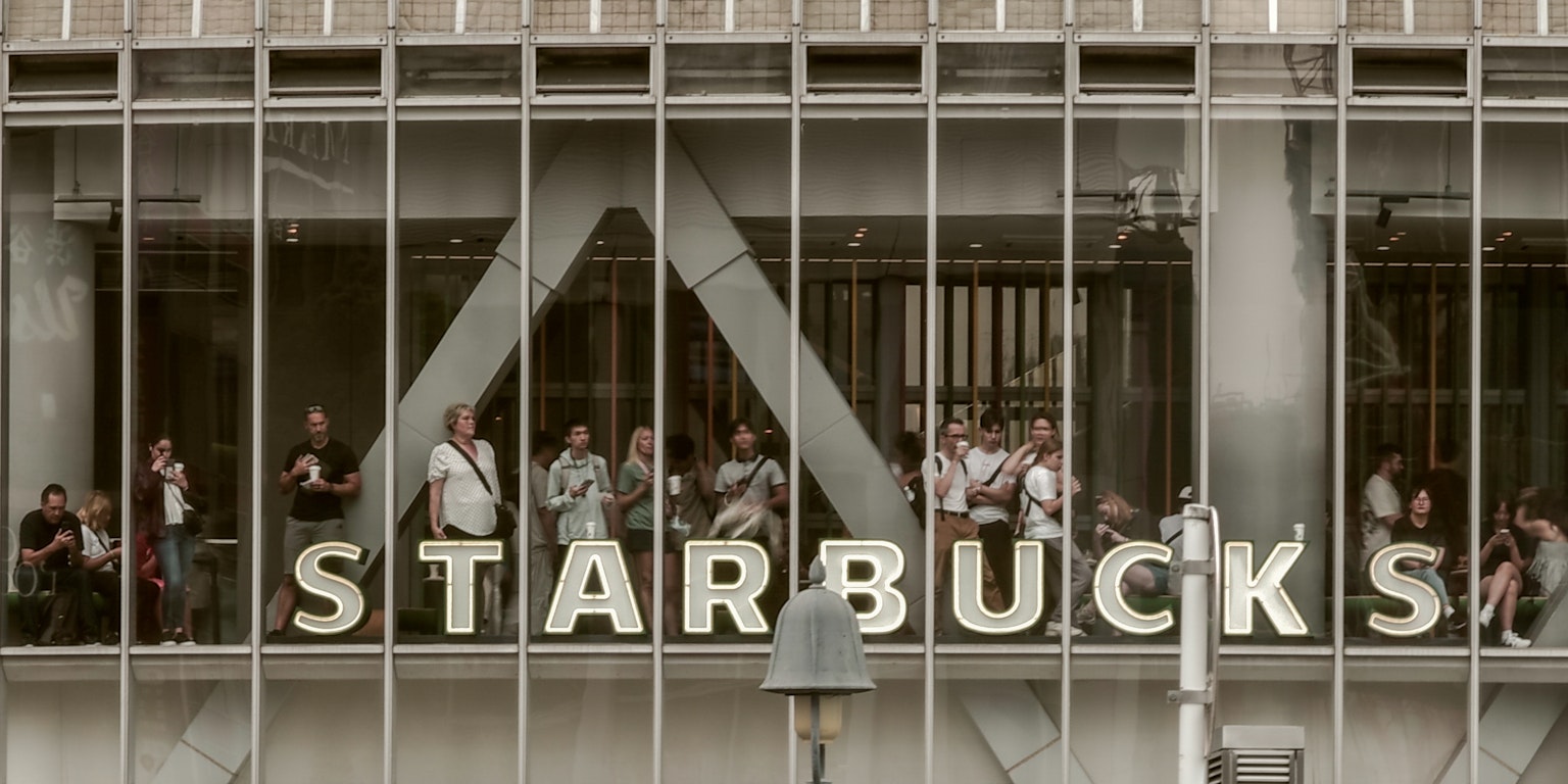 Starbucks storefront with people gathered by the windows