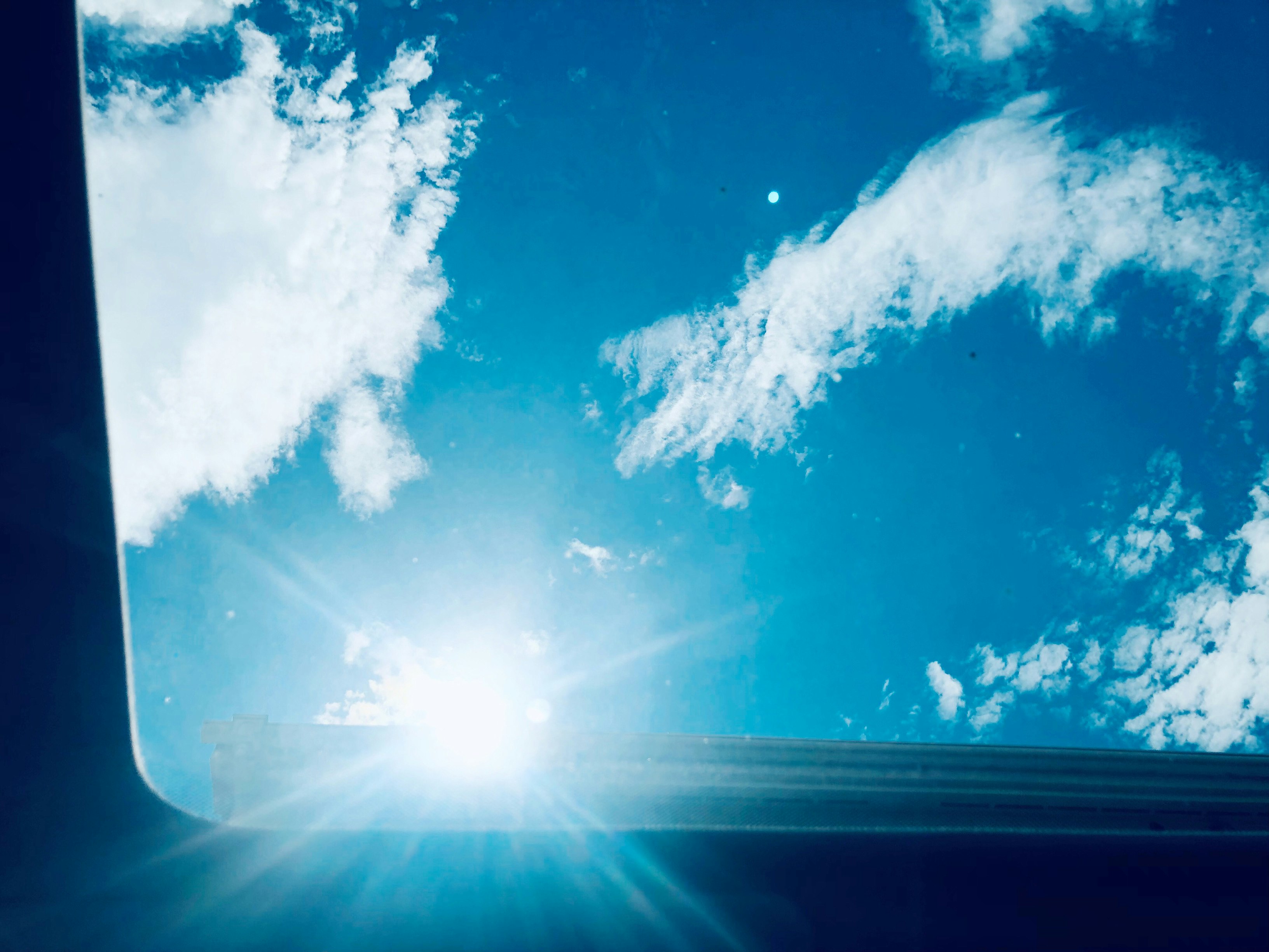 Backlit view of autumn sky from inside a car during lunch break