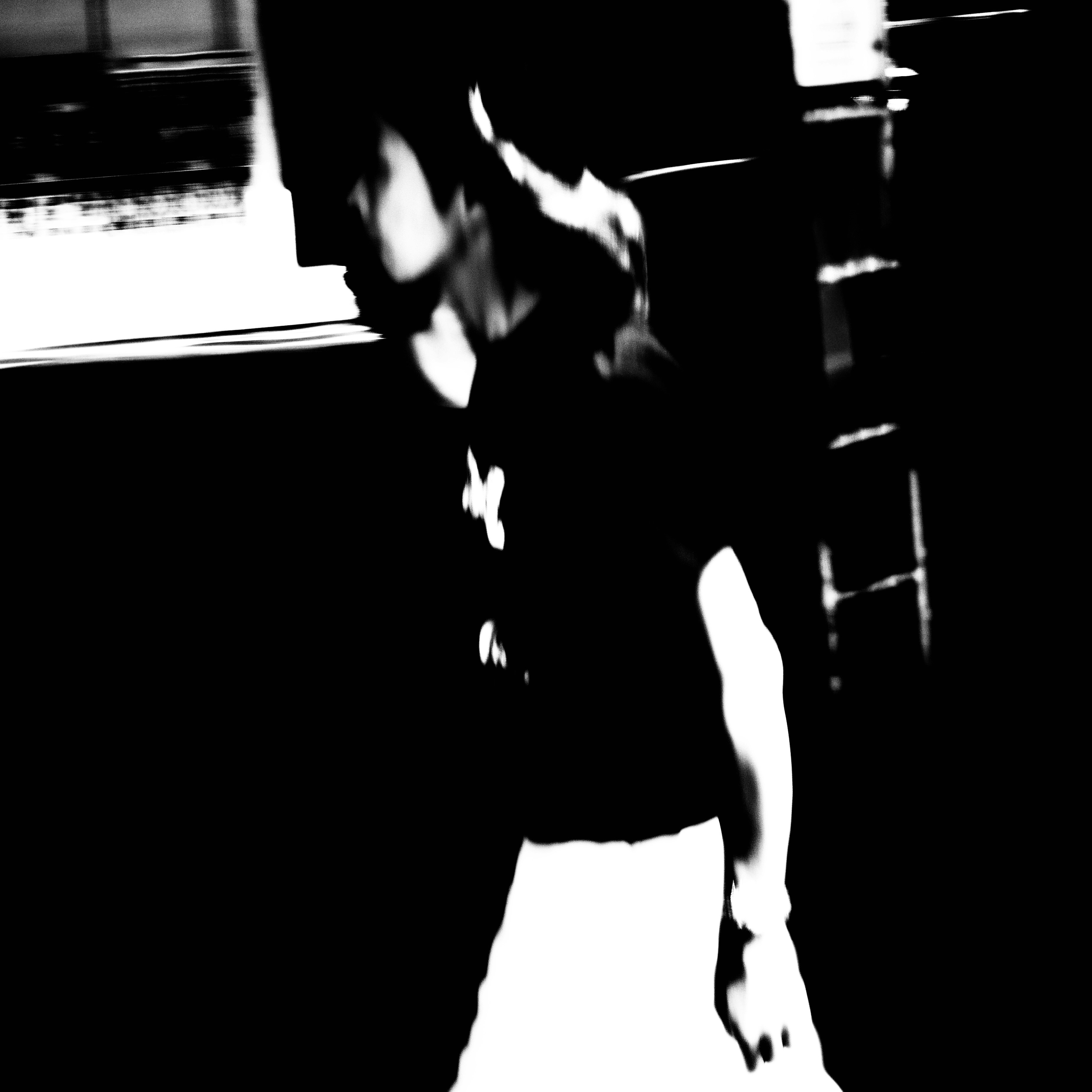 silhouette of a person reaching out against a dark background