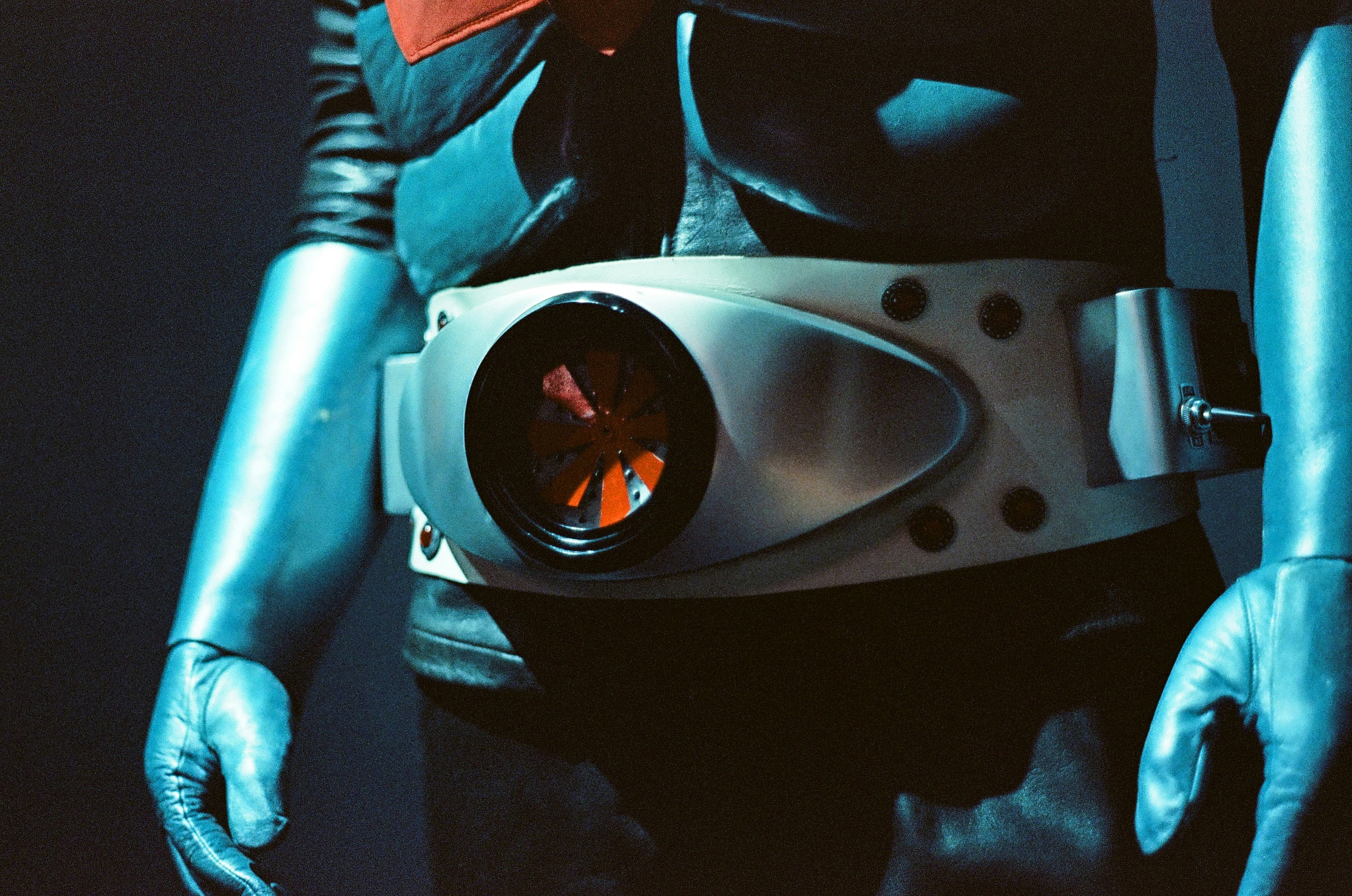 宇宙服のような衣装を着た人物の胸元とヘルメットのアップ