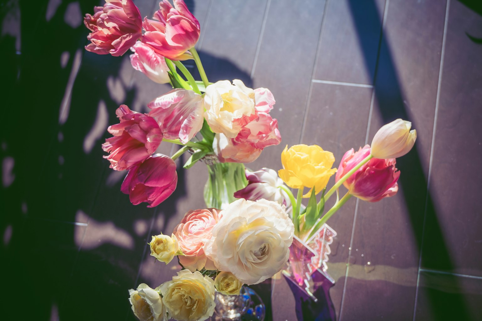 Colorful arrangement of flowers featuring prominent tulips and ranunculus