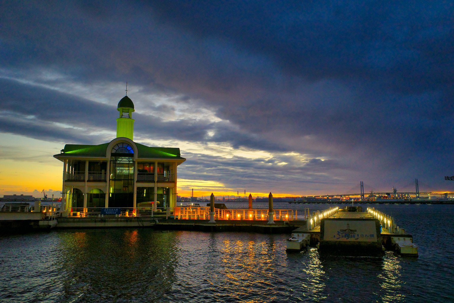 Hermoso edificio junto al mar al atardecer con reflejos en el agua
