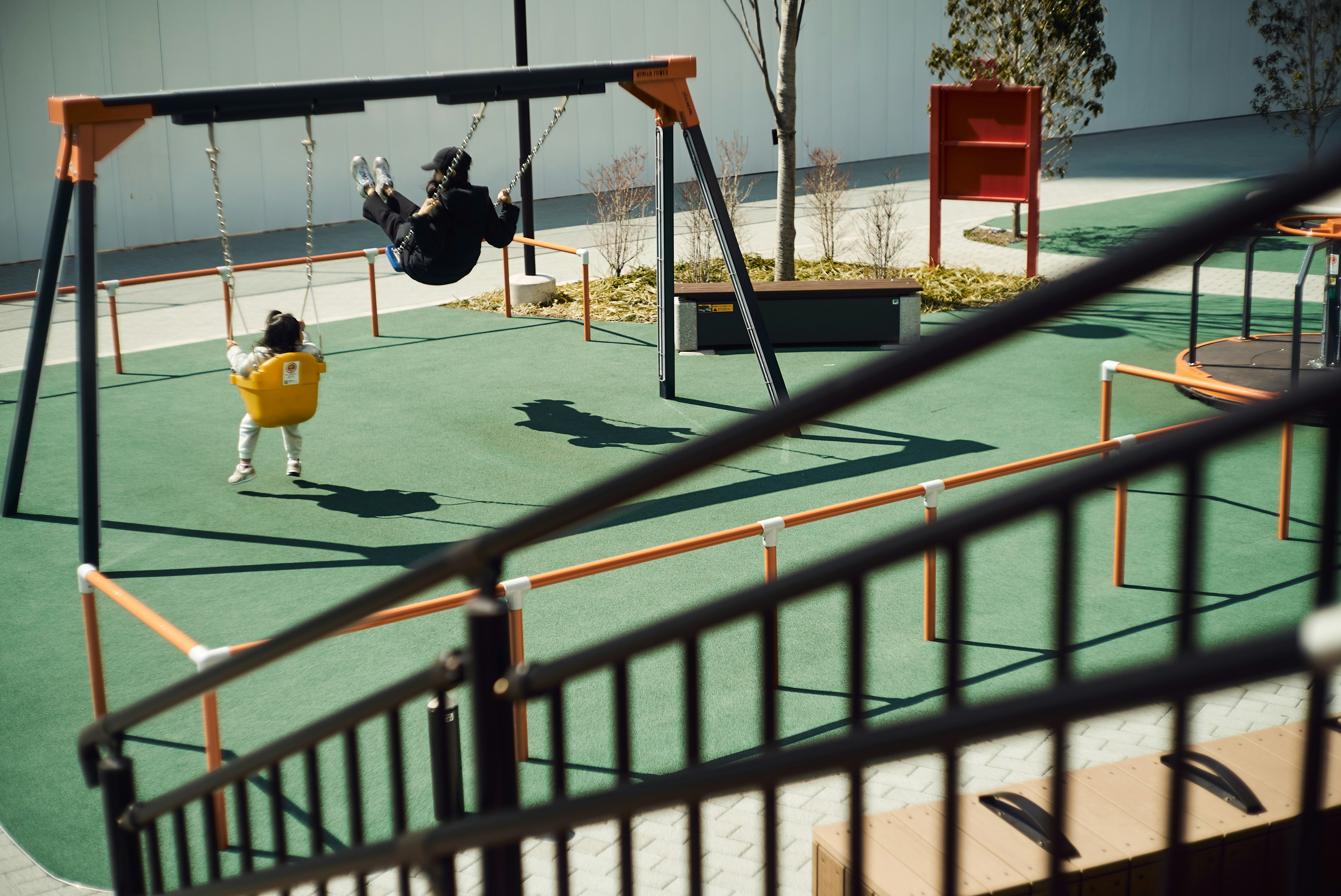 A child on a swing in an outdoor playground