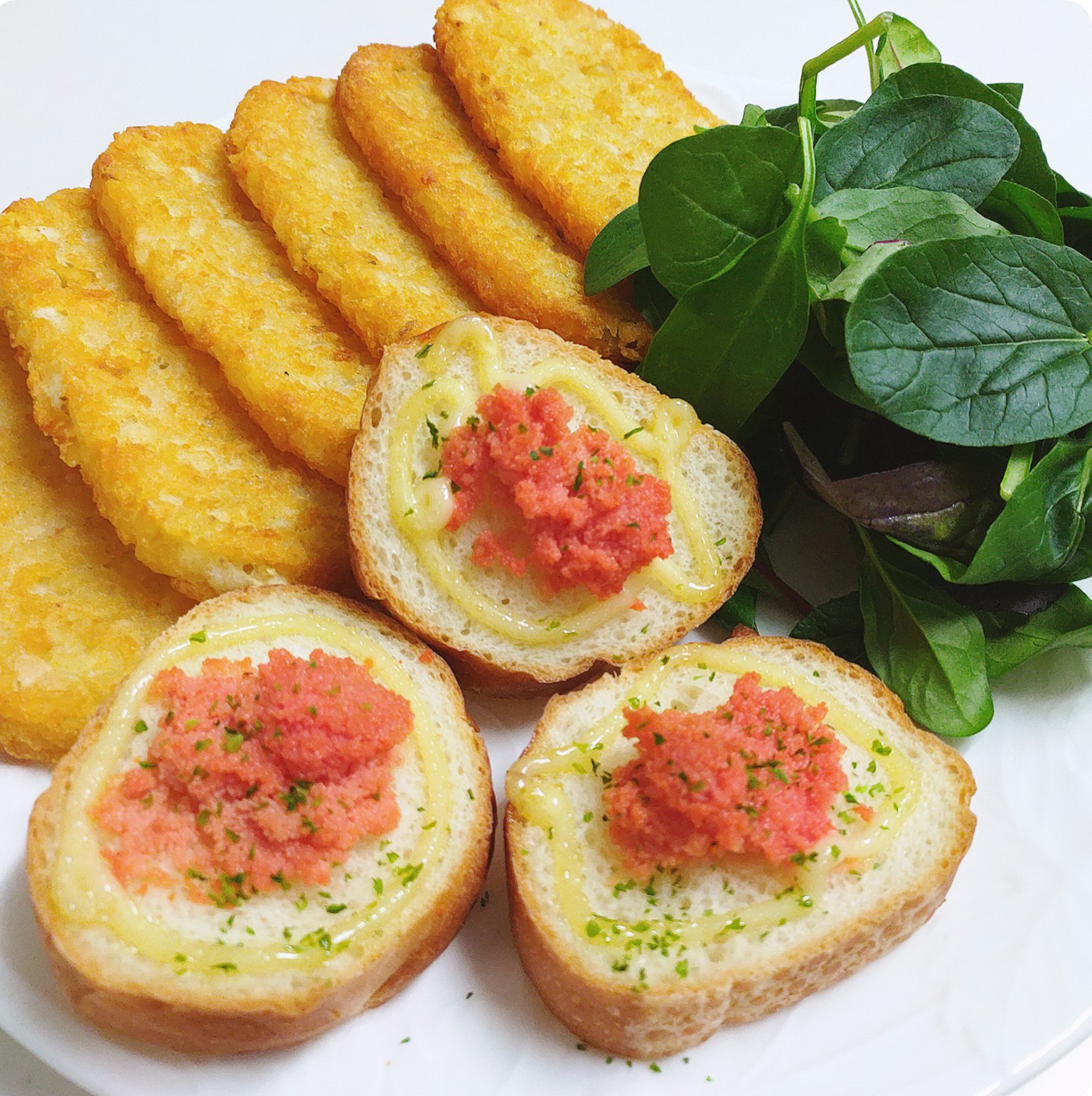 Crispy hash browns with creamy salmon rolls on a plate