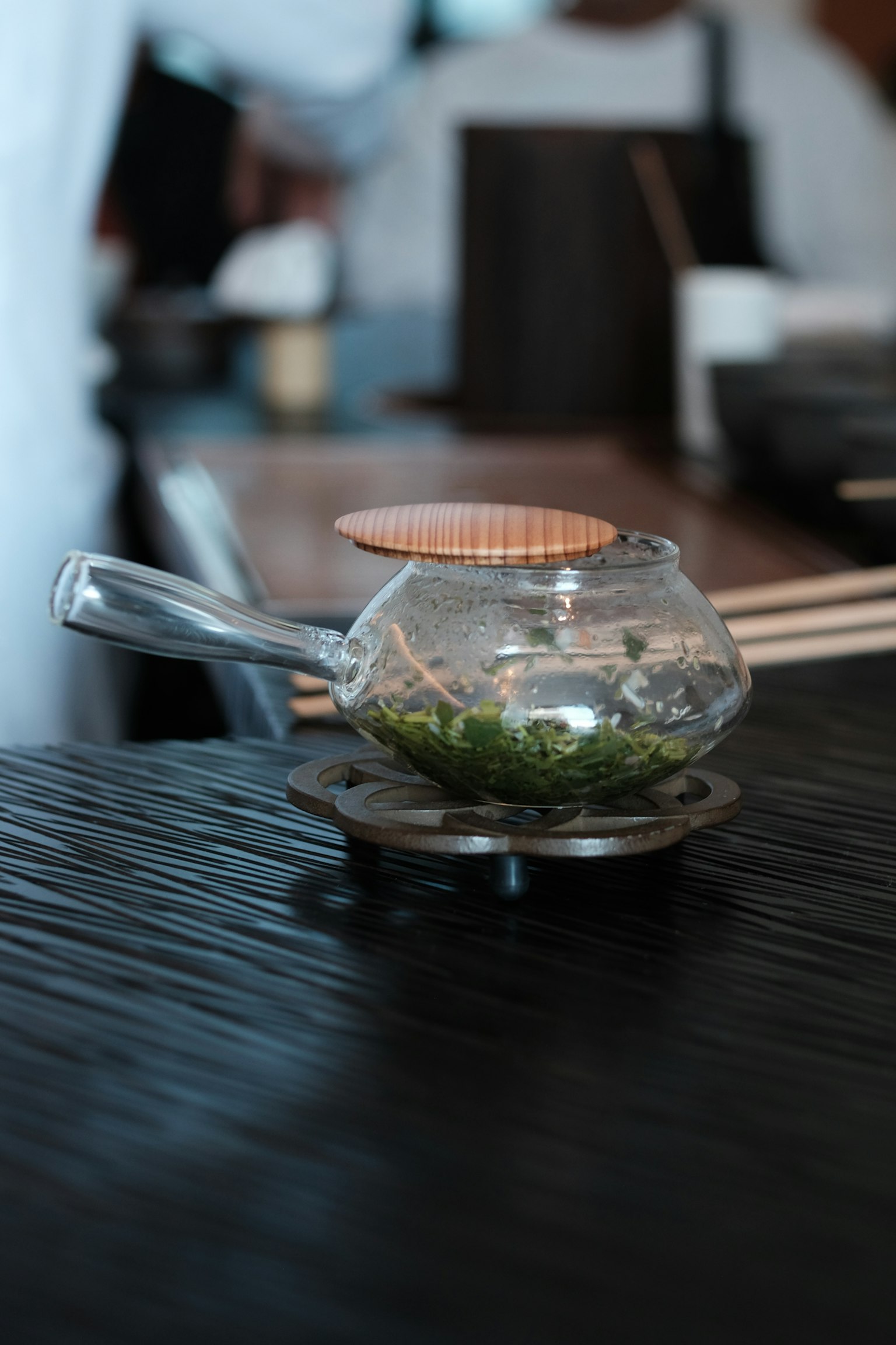 투명한 찻주전자에 녹차 잎이 있는 모습