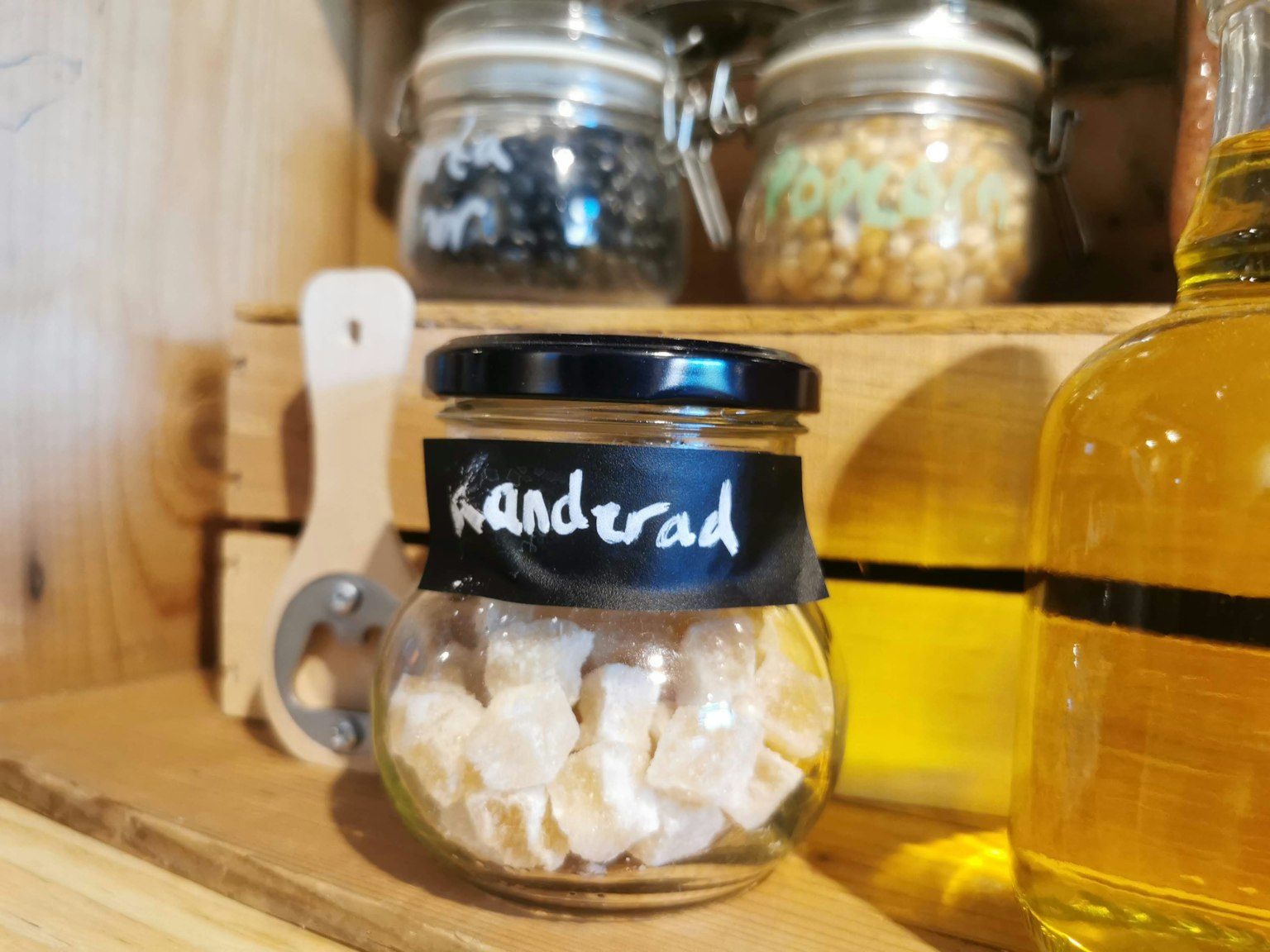 Transparent jar containing handrad with wooden shelf in background