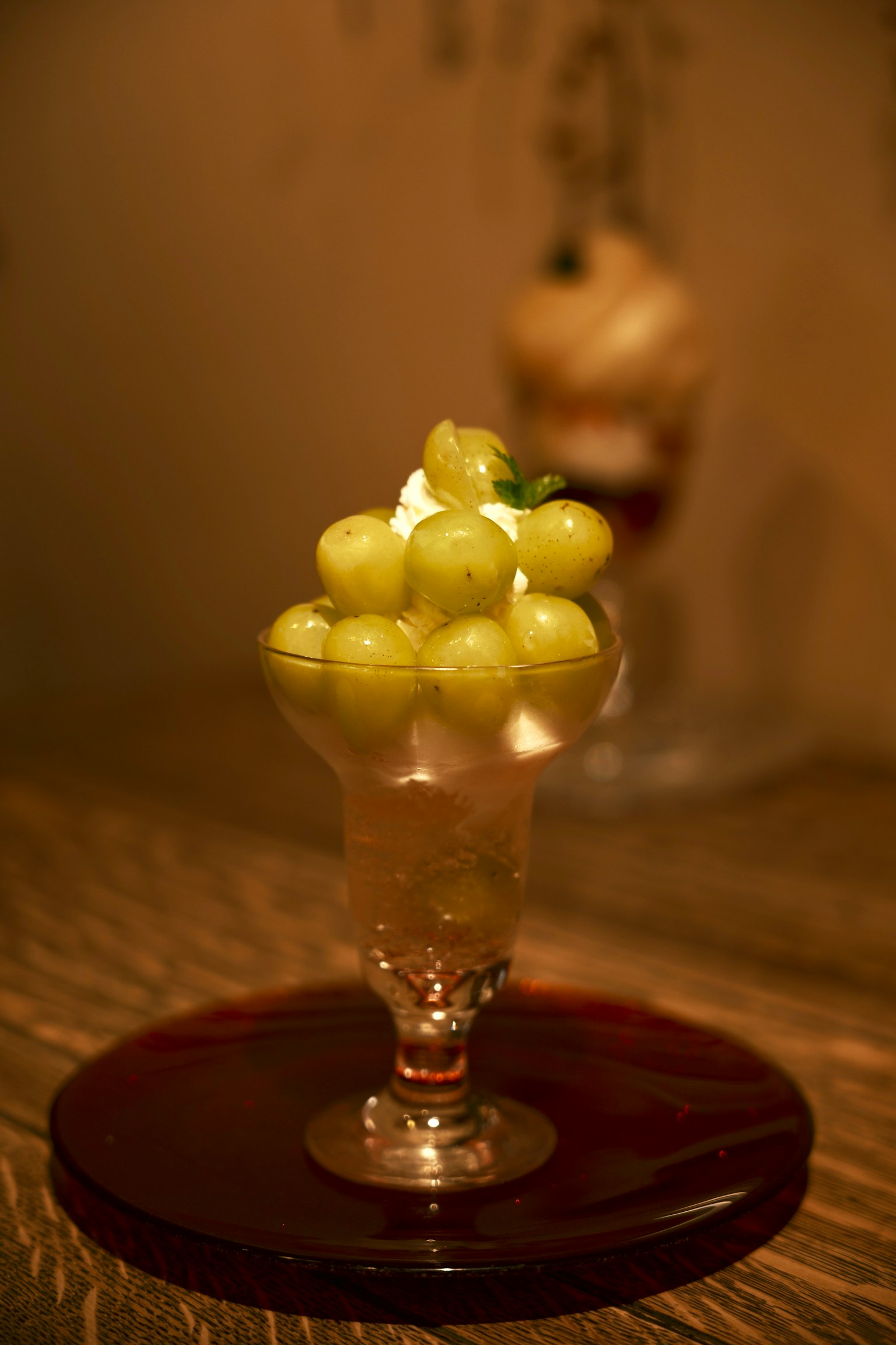 Dessert featuring green grapes served in a clear glass