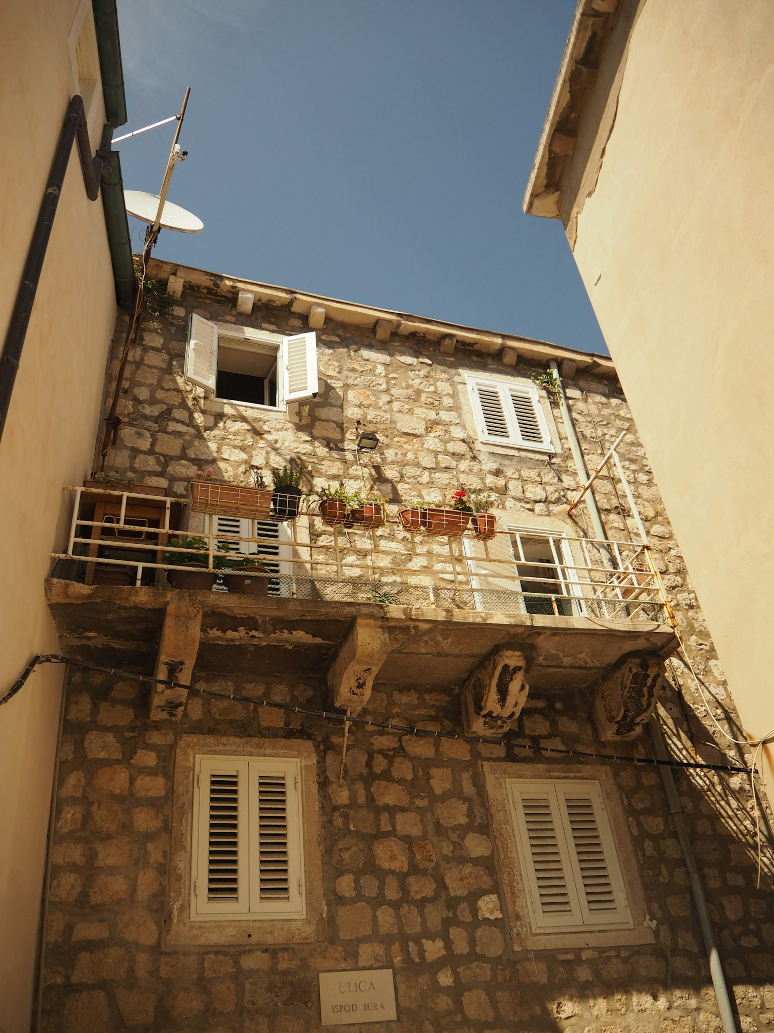 Stone building with white windows and balcony