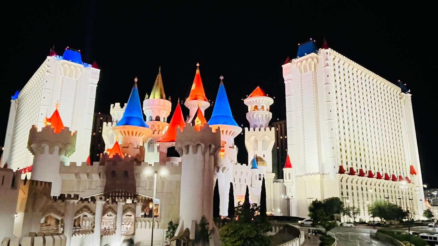 Colorful exterior of Excalibur Hotel in Las Vegas at night with illuminated towers