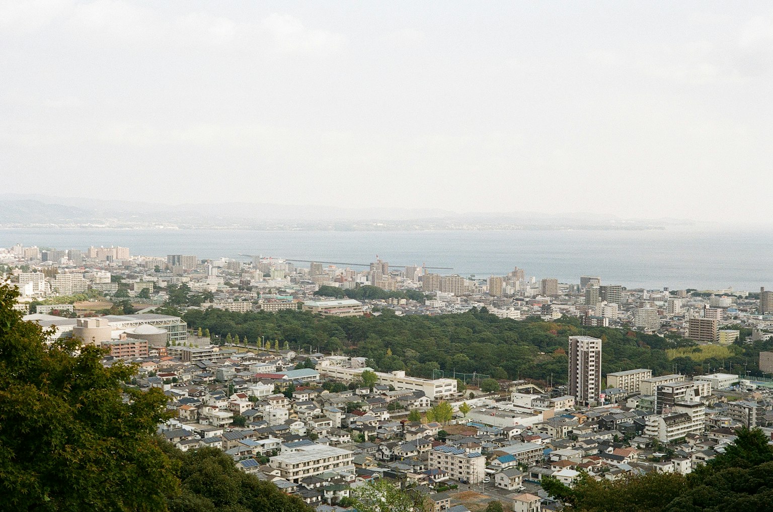 Panoramic view of a city with coastal scenery and varied terrain