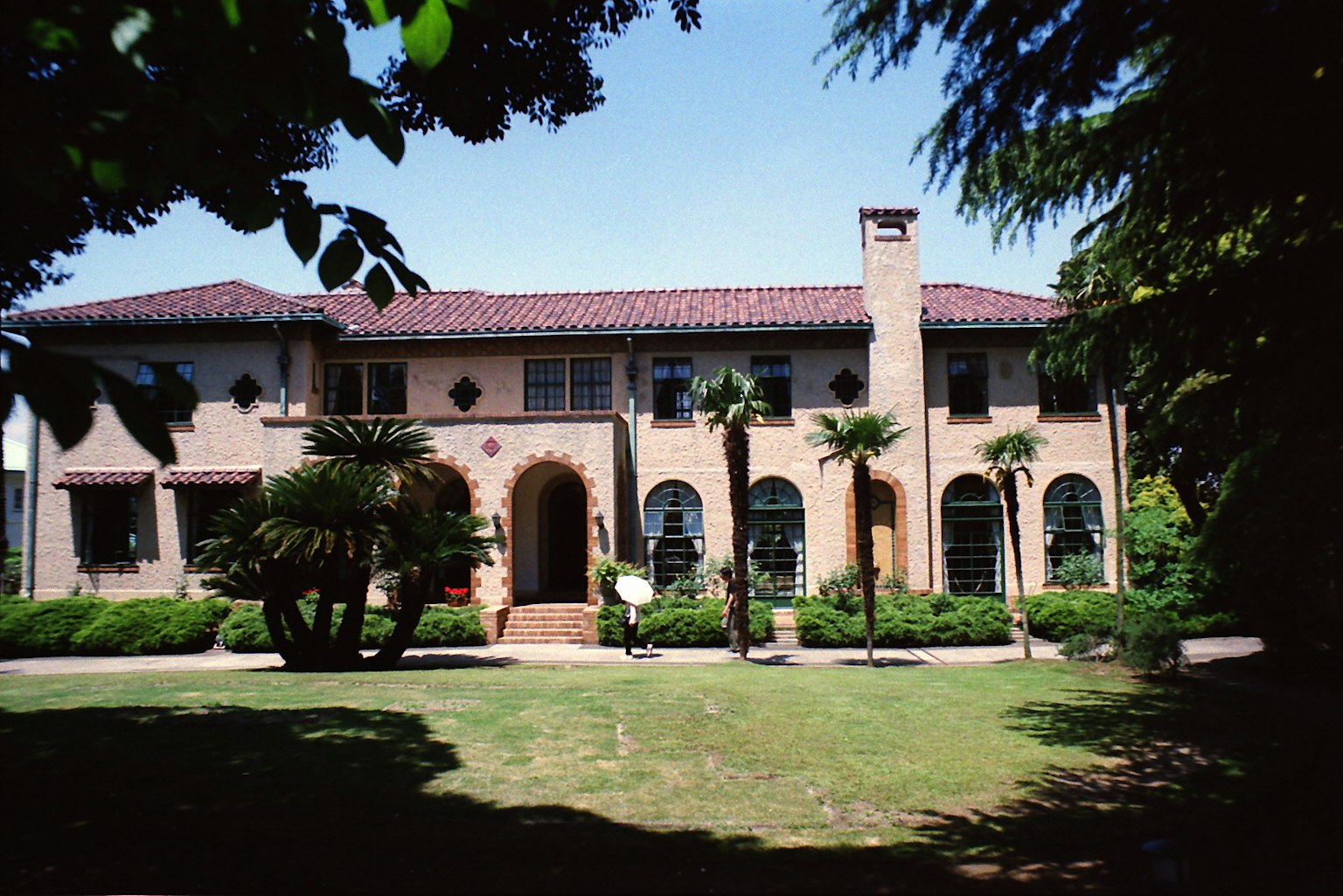 Historic house exterior surrounded by lush garden