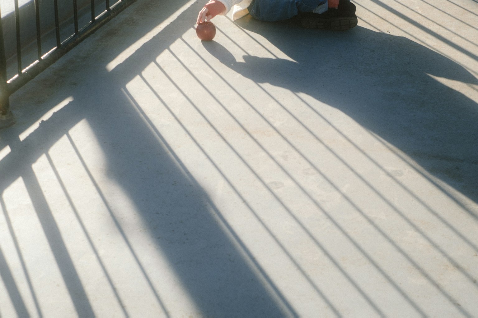 Shadows cast on the floor with a person lying down