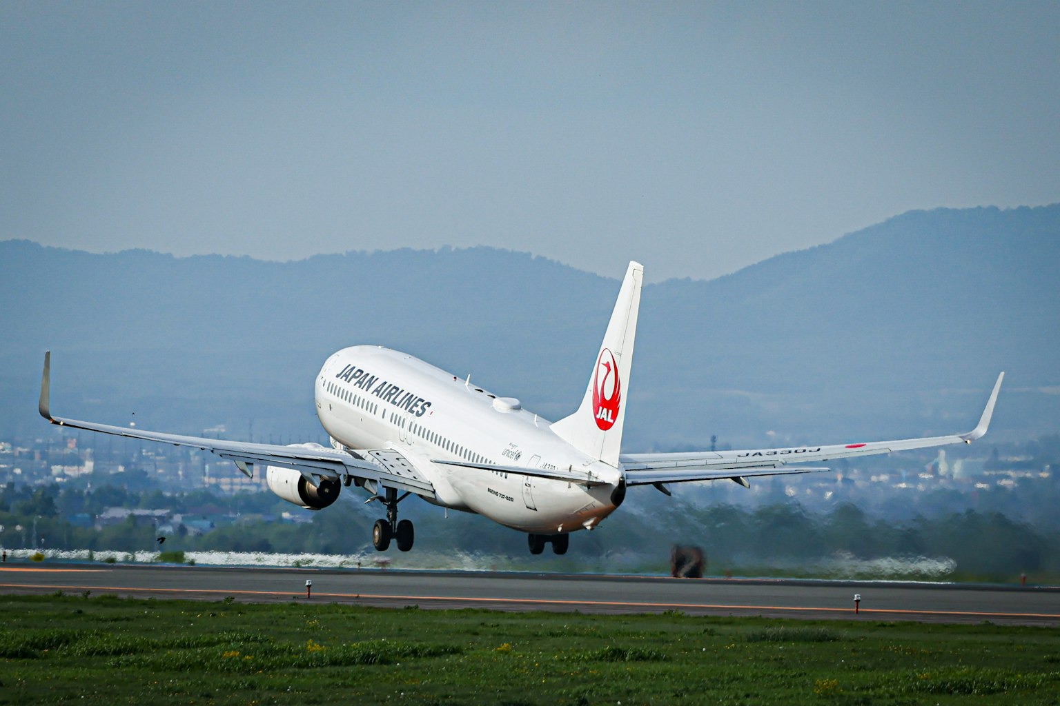 Japan Airlines airplane taking off on the runway