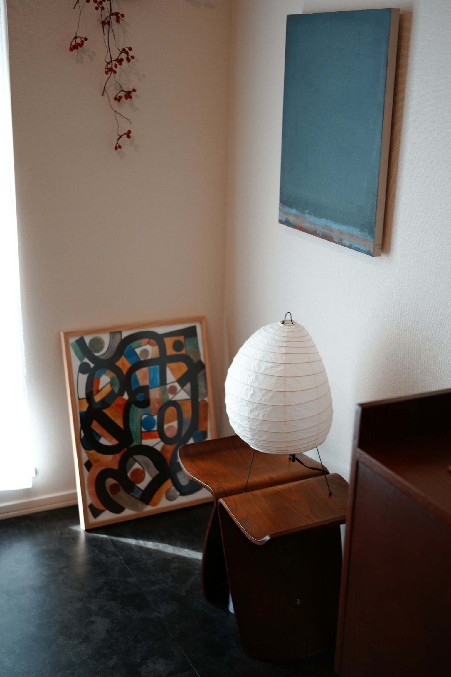 Simple interior with artwork and lamp in the corner of a room