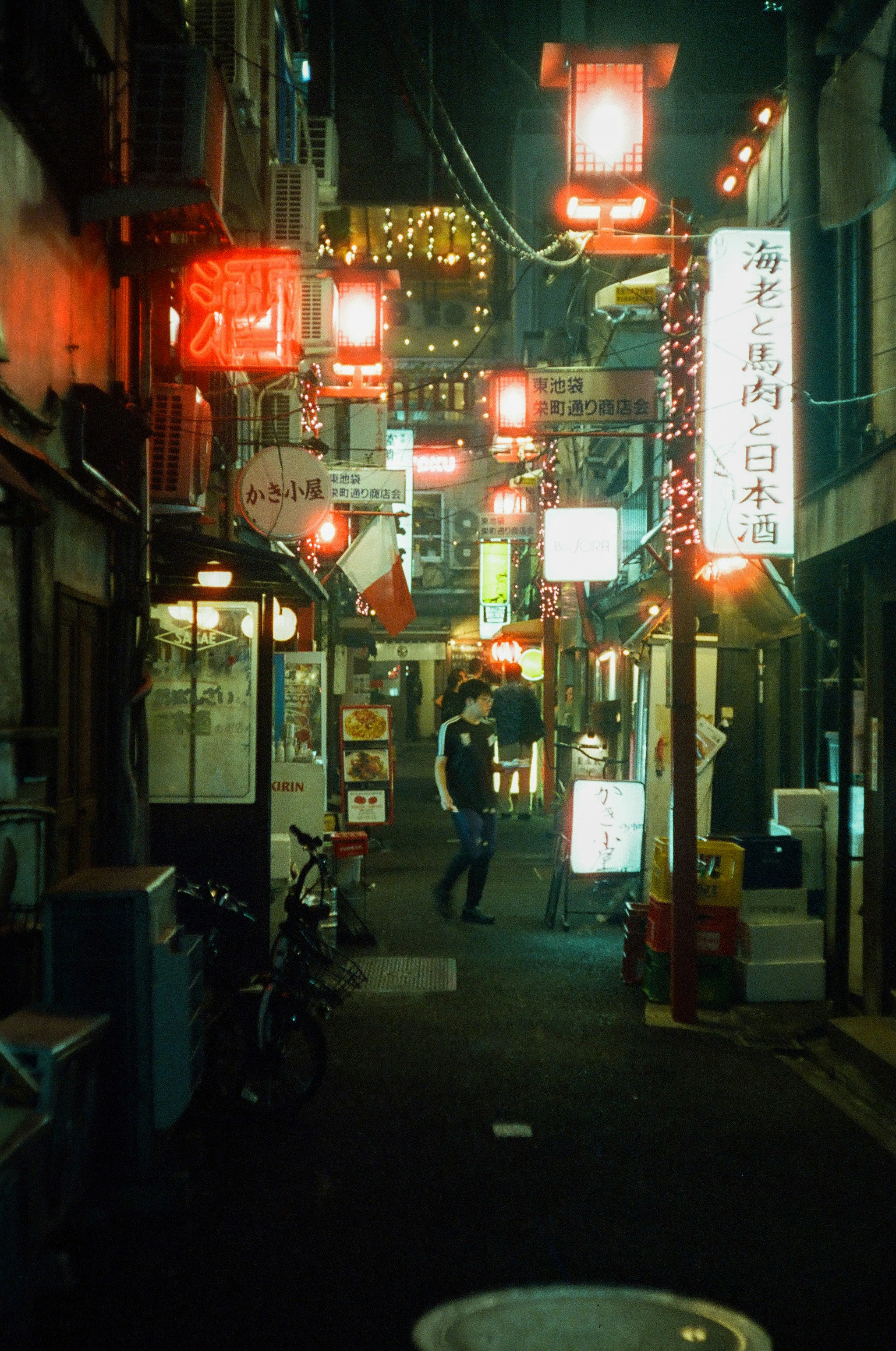 vue nocturne d’une ruelle bordée de restaurants aux lanternes