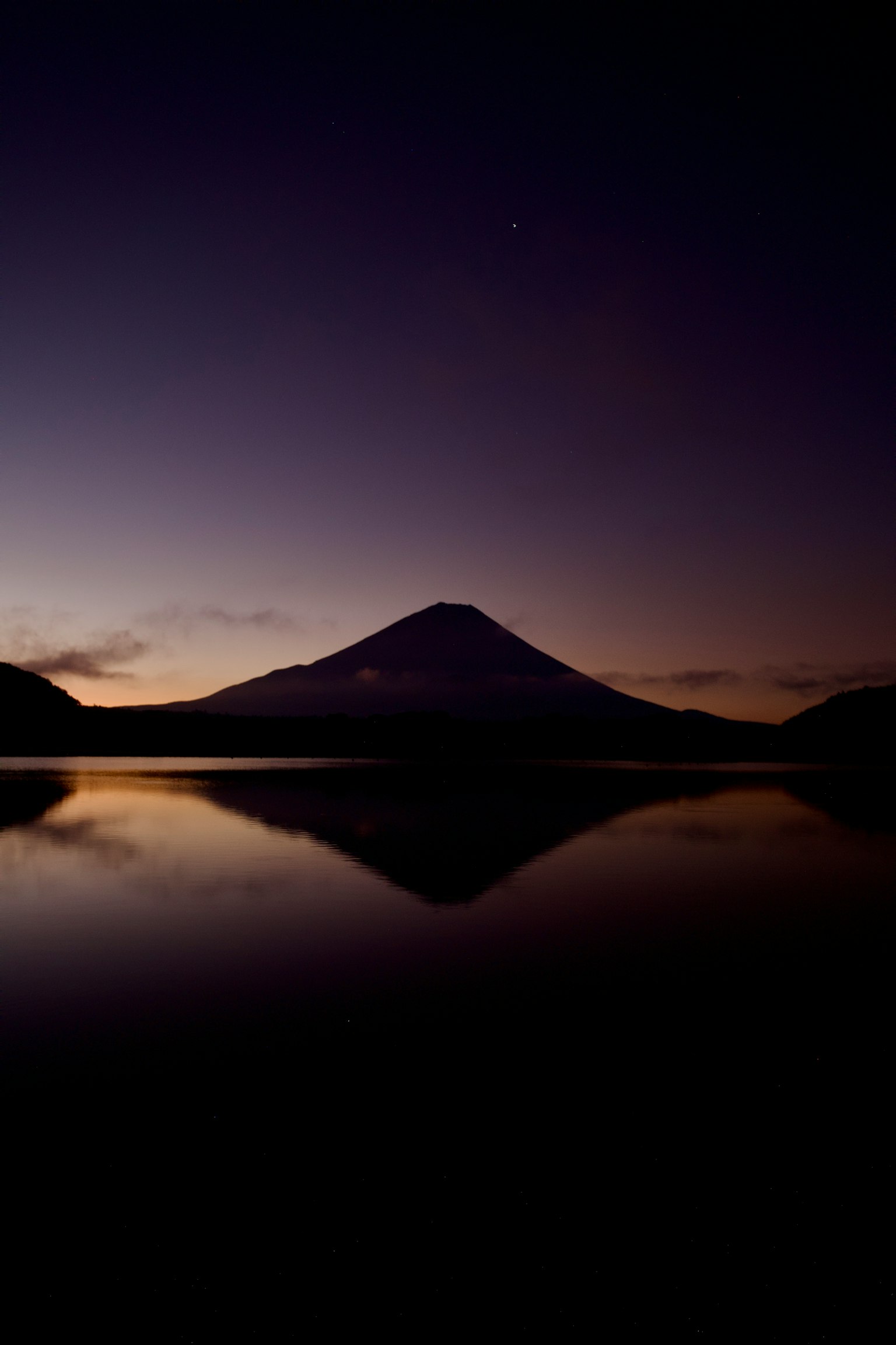 Serene sunrise landscape with Mount Fuji reflected in the lake