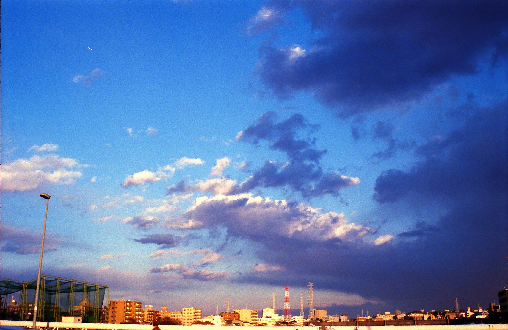 dusk sky over an industrial harbor with smokestacks