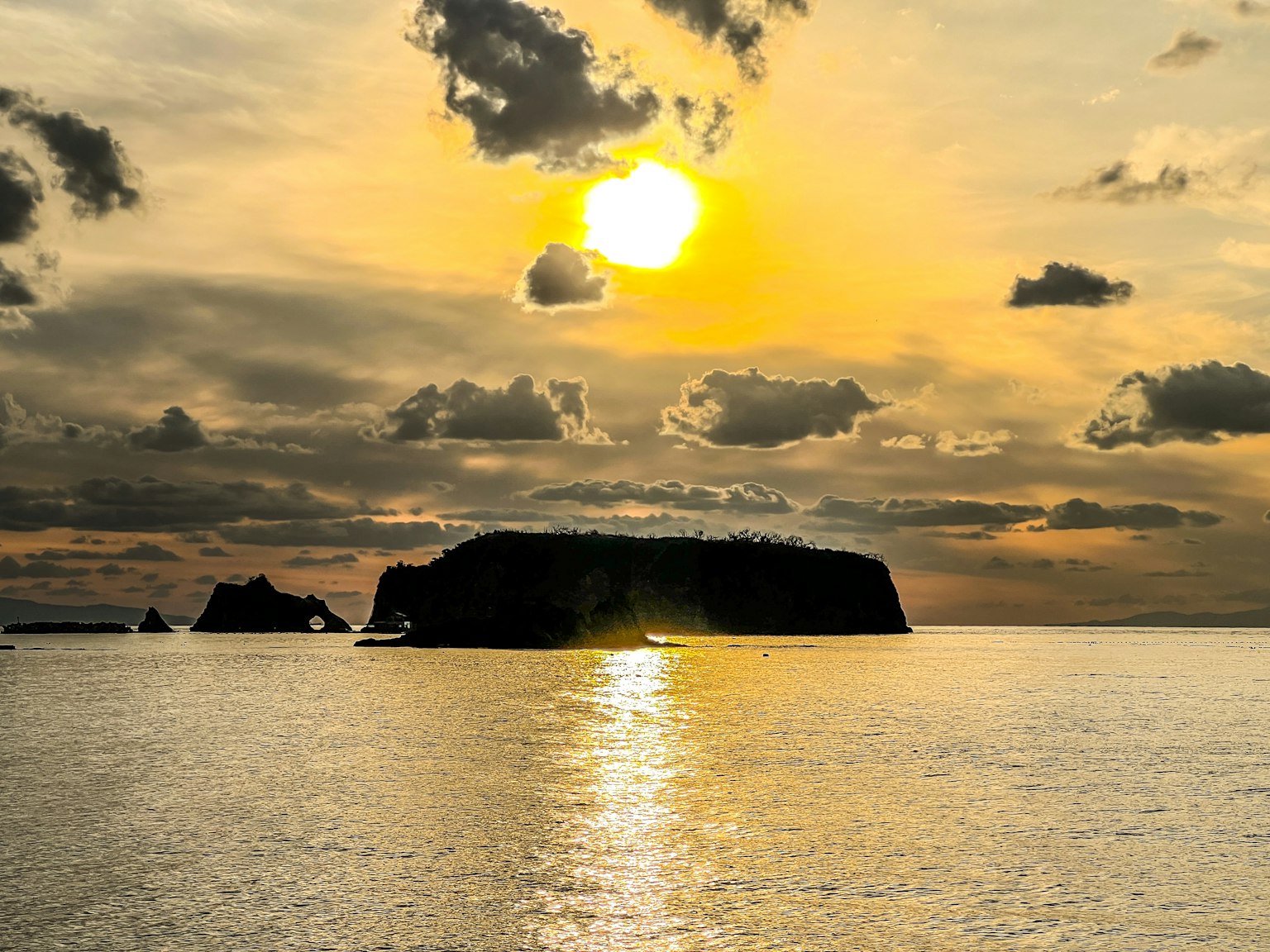 Tramonto sull'oceano con la silhouette di un'isola