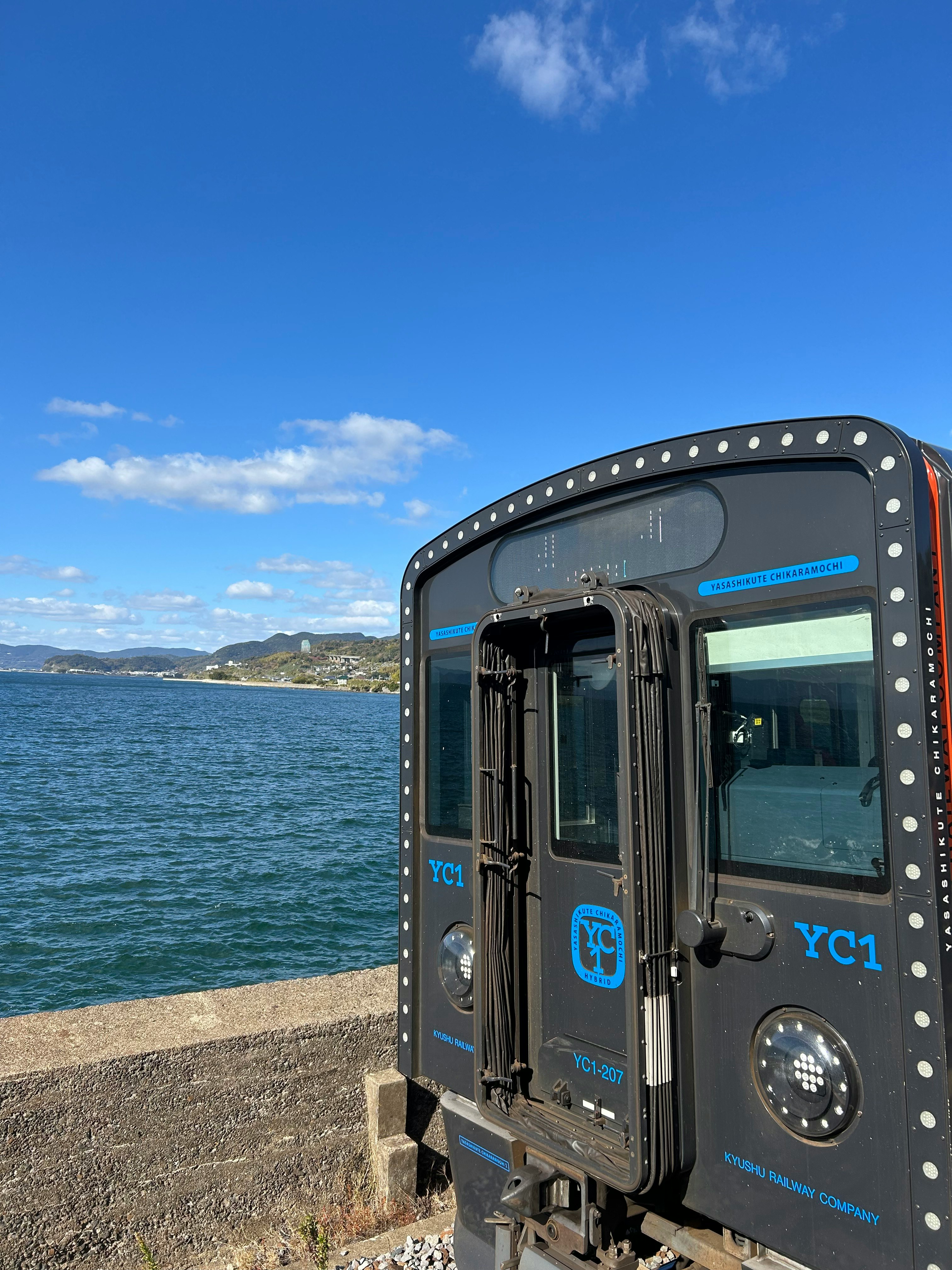 冬の海辺に停車する車両と青い空の風景