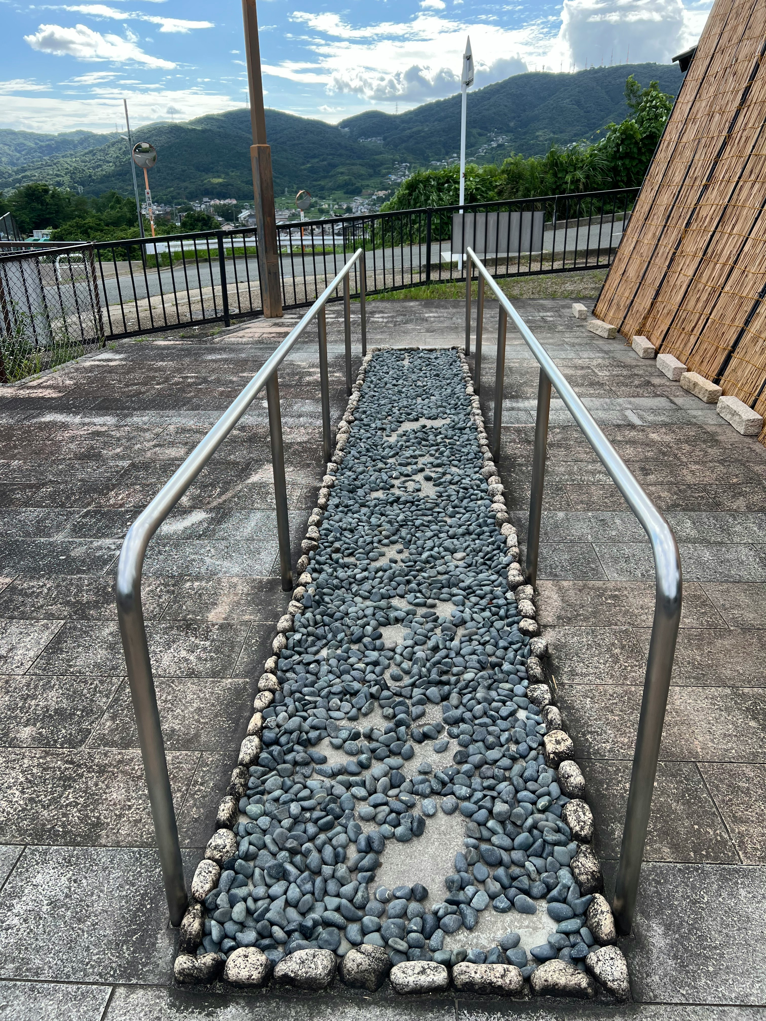 stone-lined walkway on a viewpoint with mountain scenery