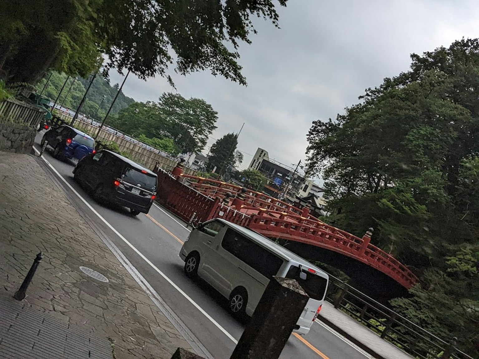 Scenic view of a red bridge with vehicles on the road
